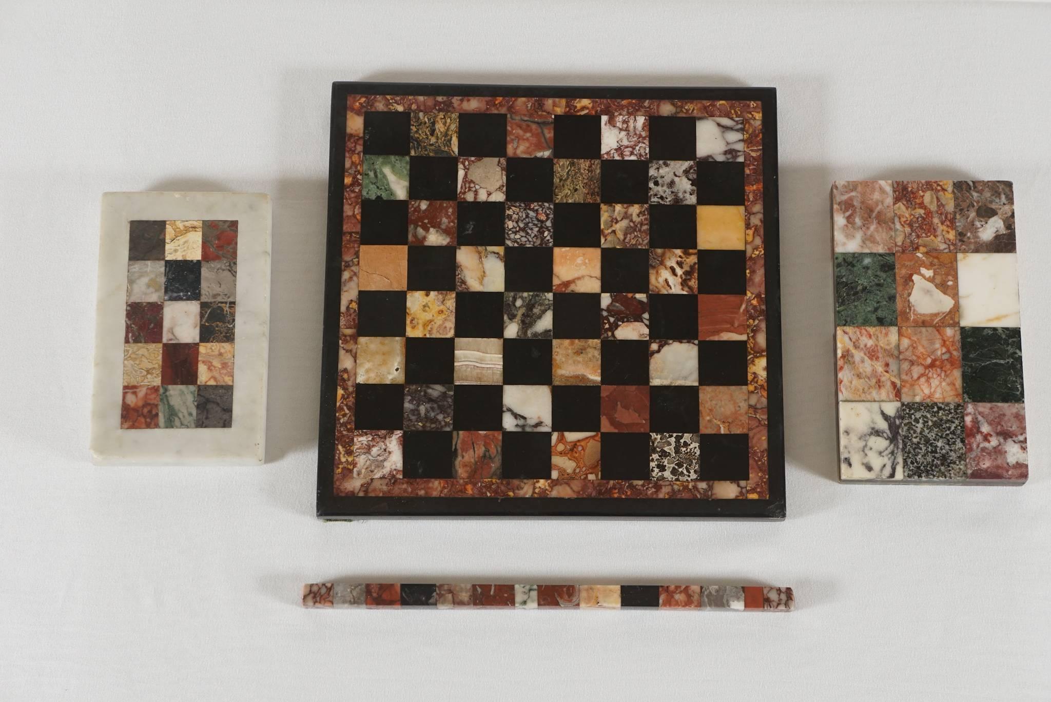 Wonderful collection of four 19th century Italian Grand Tour pietra dura specimen marble articles comprised of a game board, two paperweights, and a ruler or straight-edge, all with geometric inlay of rare and ancient marbles, including various
