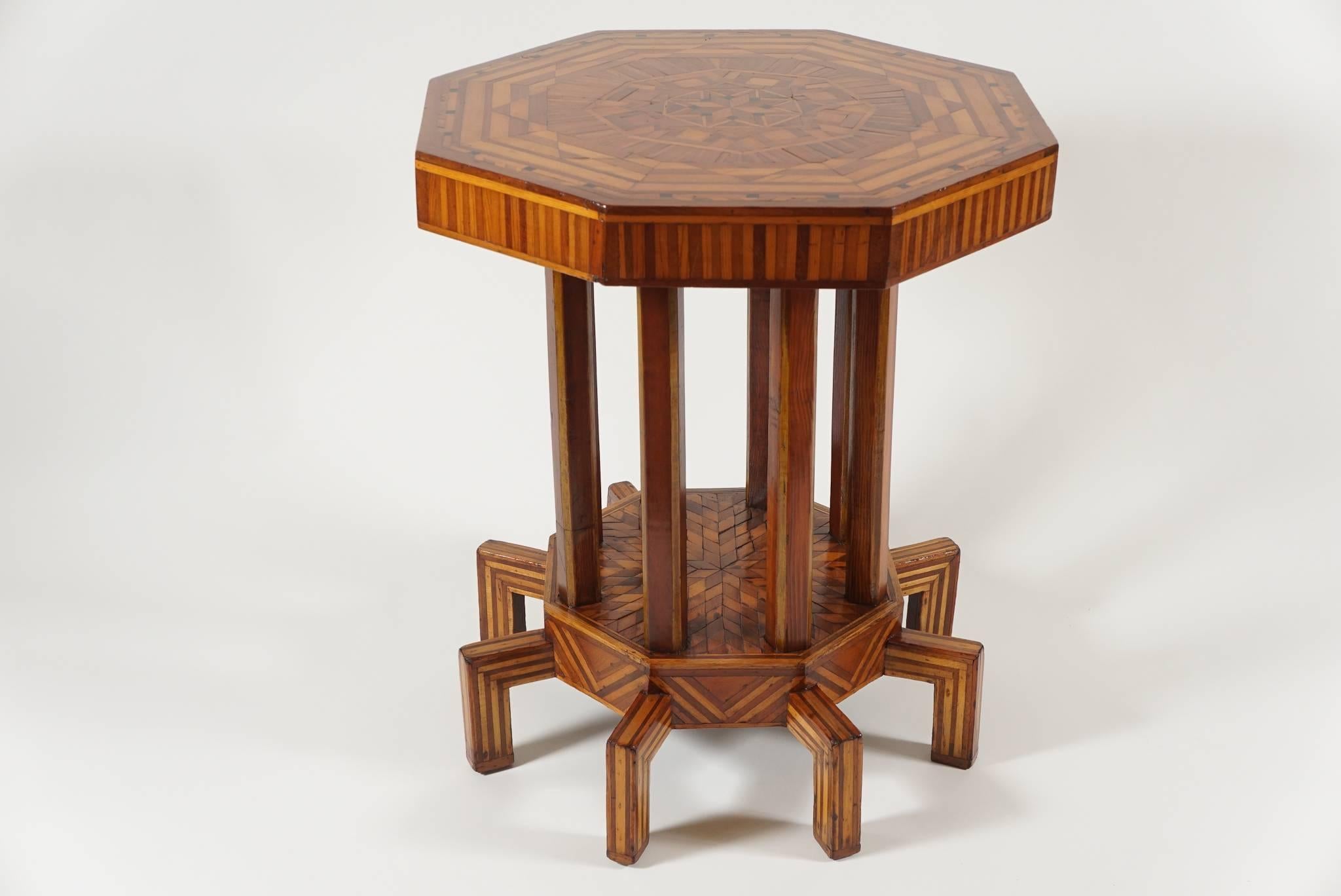 A truly remarkable and remarkably rare Vienna Secessionist period and style specimen wood parquetry table of octagonal form having all-over intricately geometric inlaid woods, including ebony.