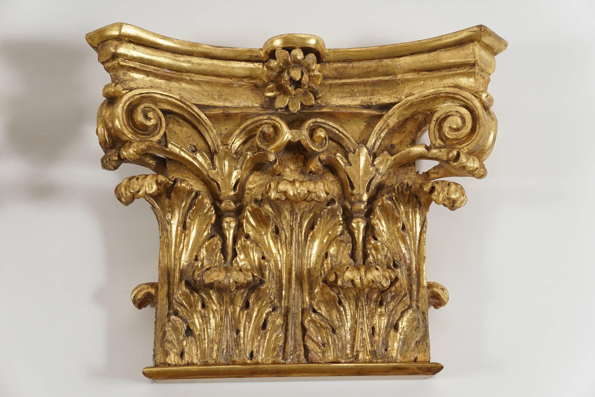 An exceptional set of four late 18th-century, English George III period carved and giltwood wall brackets of large-scale in the form of Corinthian pilaster capitals having original gilded finish.