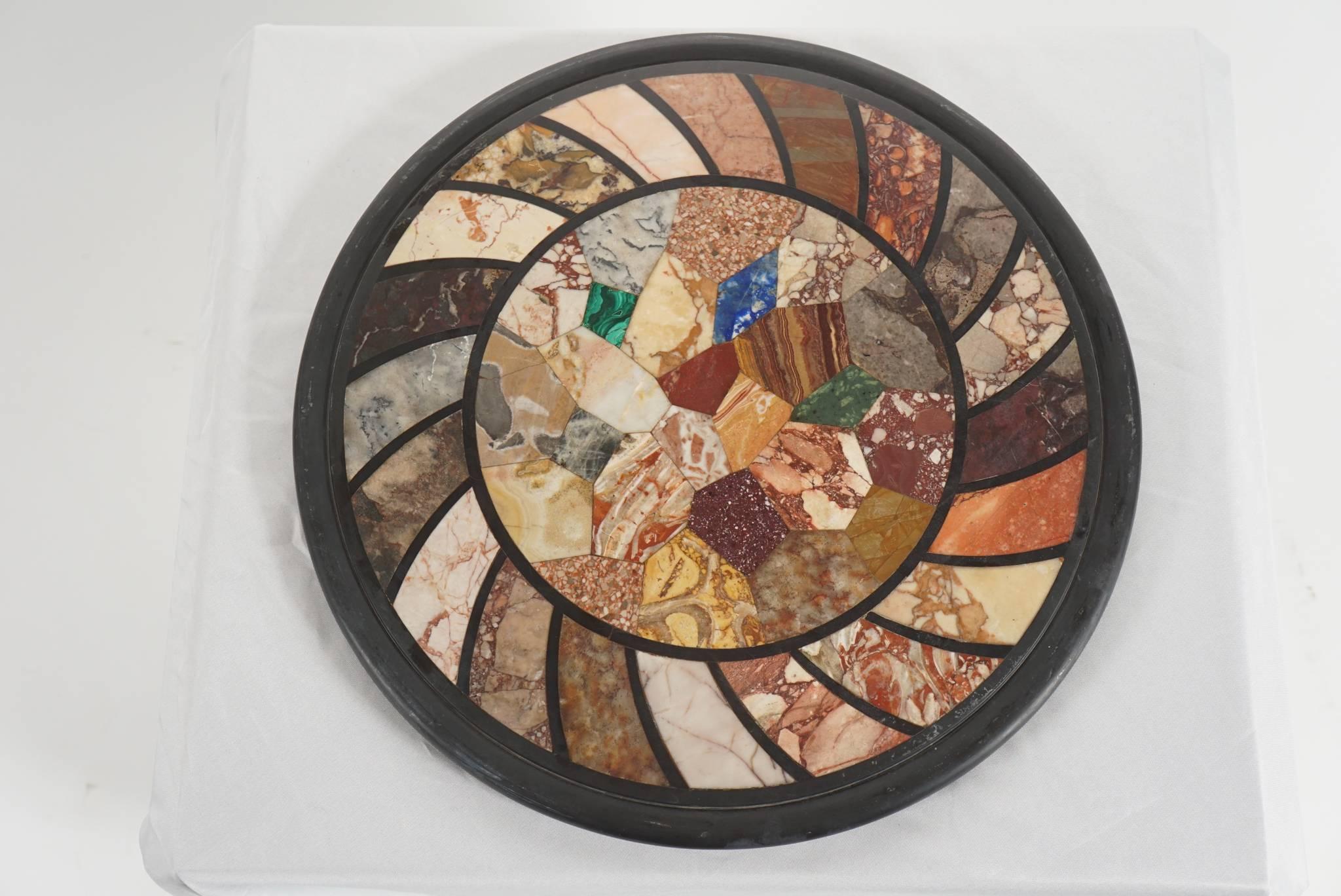 Third-quarter 19th century Italian 'Grand Tour' specimen marbles plaque of roundel form having over 30 different rare and ancient marbles, including malachite, porphyry, jasper, and giallo antico. Originally meant for use as a tabletop and never