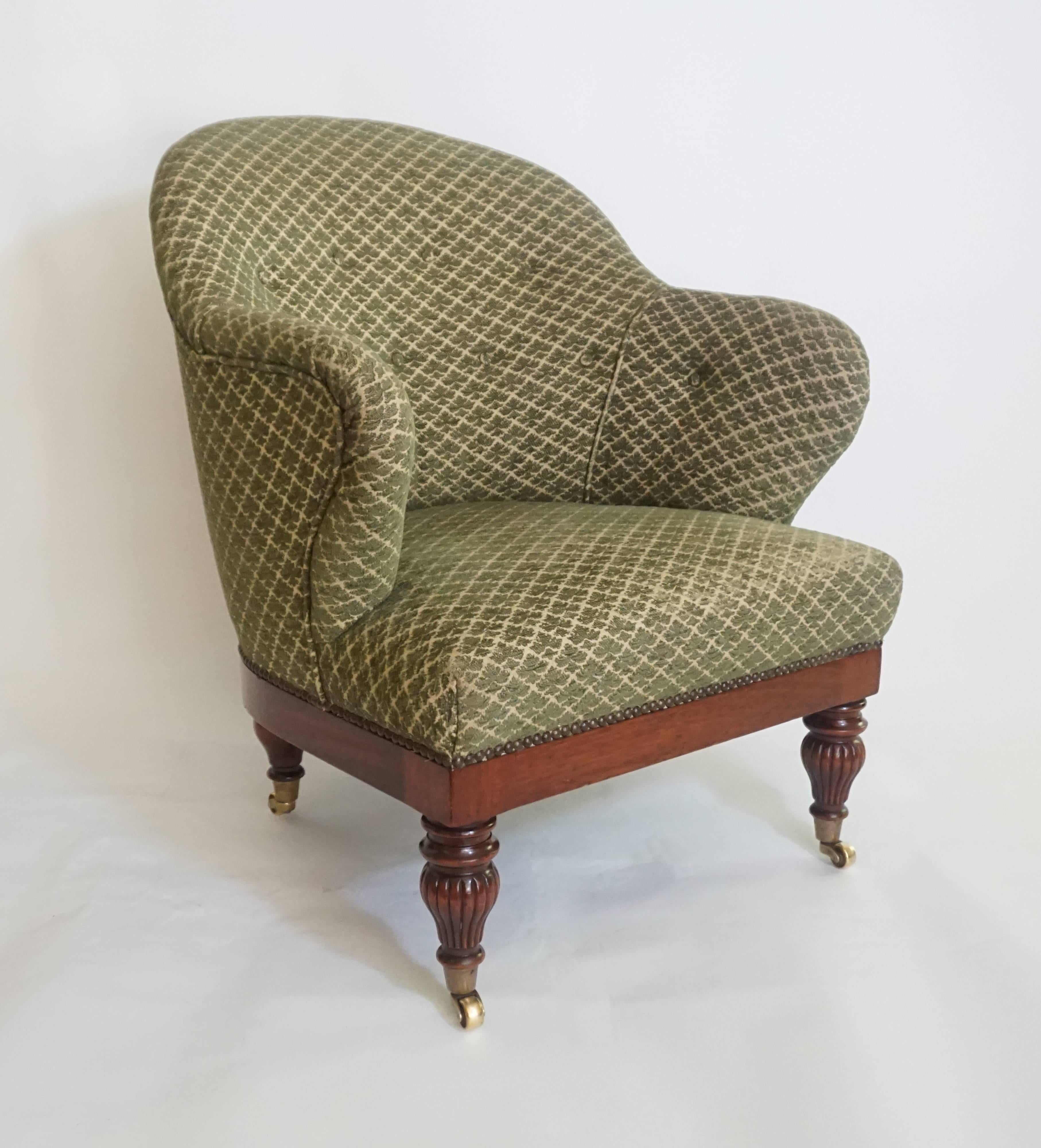 English Regency style Edwardian period tub or club chair attributed to famous London firm Howard and Sons having upholstered frame with 