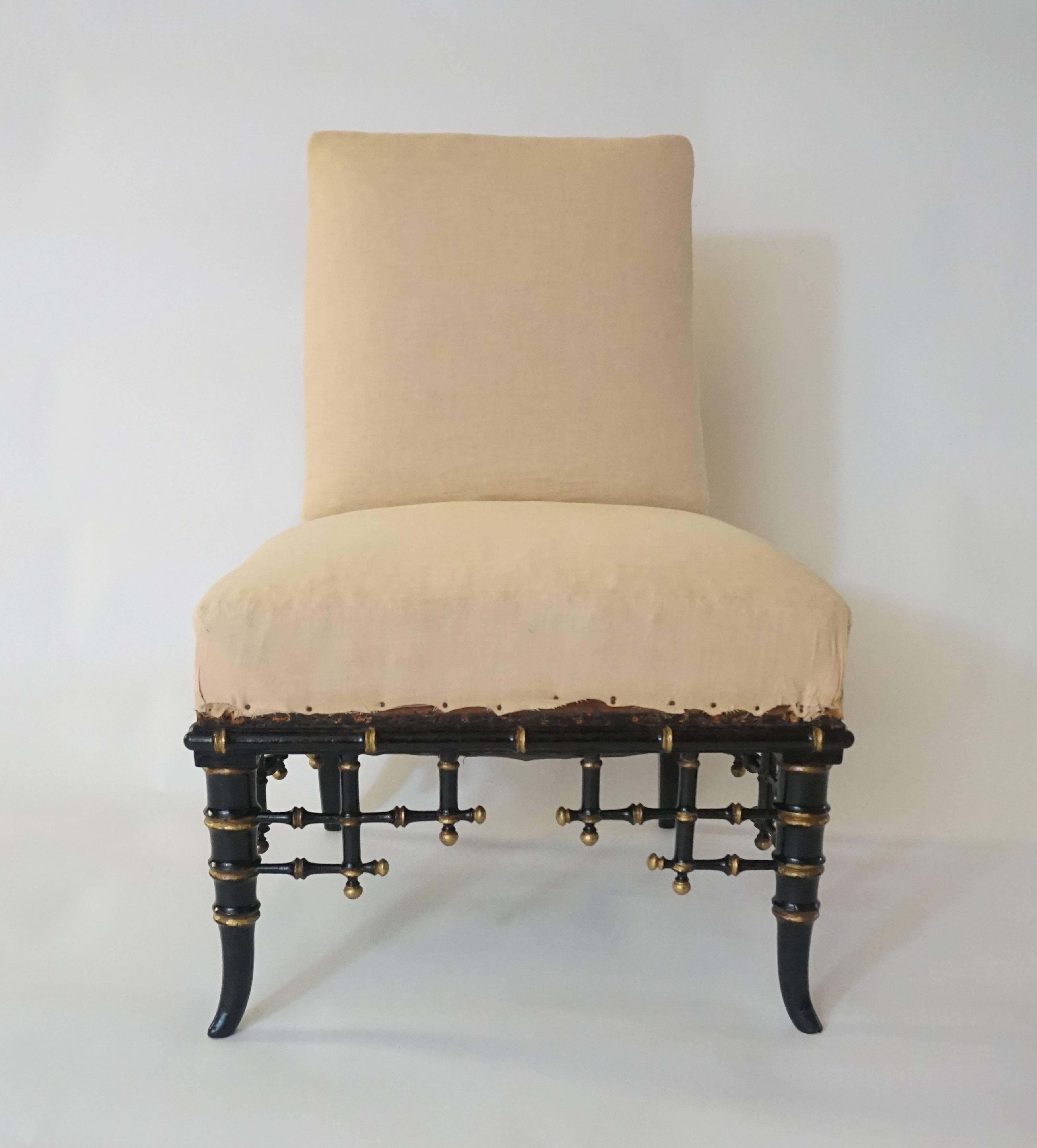 French, Napoleon III period, circa 1860, chinoiserie slipper chair having upholstered back and seat on ebonized and parcel-gilt carved wood fretwork frame.
