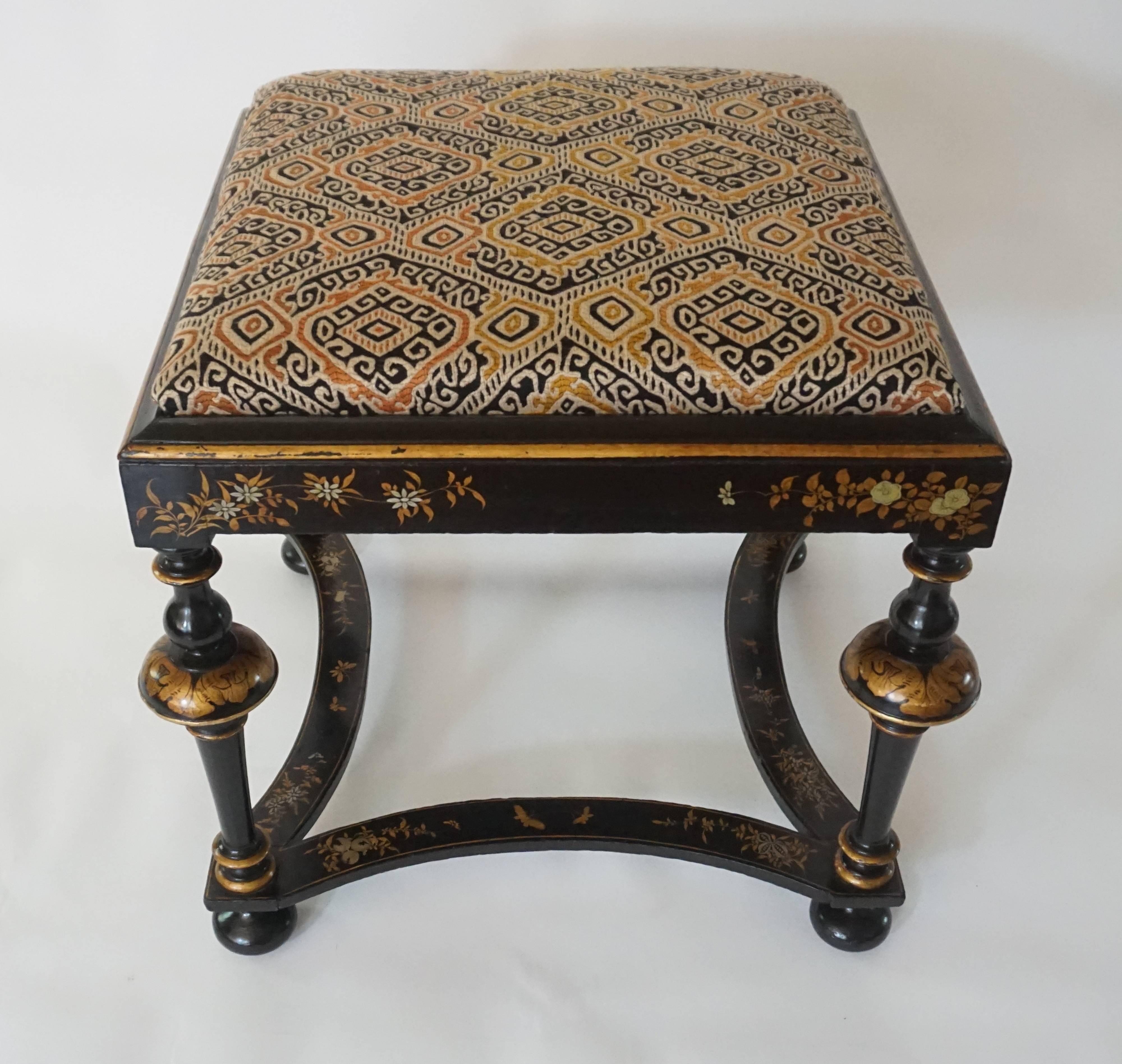 William and Mary chinoiserie style black lacquer low stool or tabouret having gold and silver gilt japanned foliate and insect decoration on wood frame having square upholstered seat surmounting flat seat-rails on dramatic turned supports joining