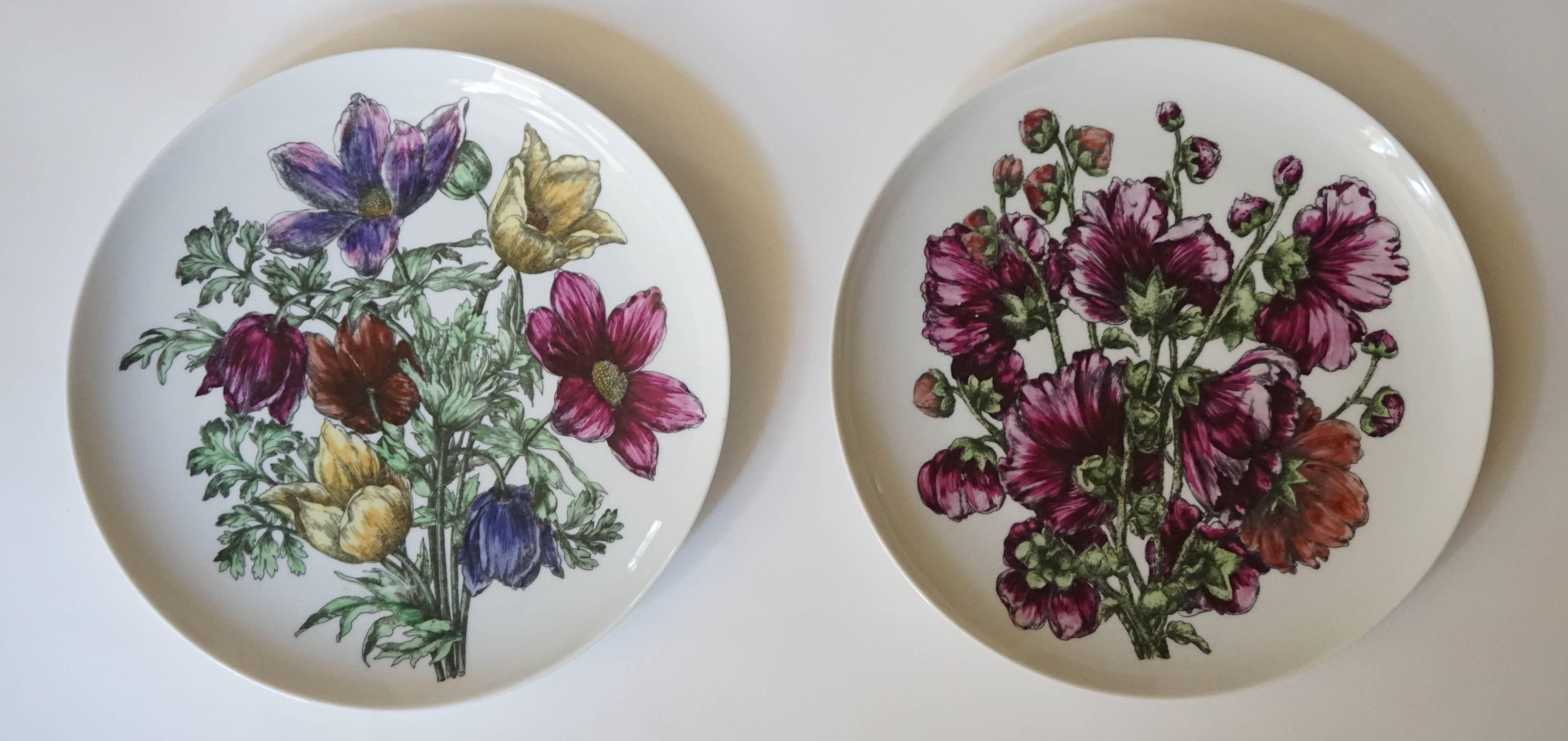An incredibly rare set of 12 large porcelain dinner plates in the 'Fiori' pattern designed by Piero Fornasetti and produced by Fornasetti - Milano, circa 1965. There are two plates of each design and are marked to the reverse 