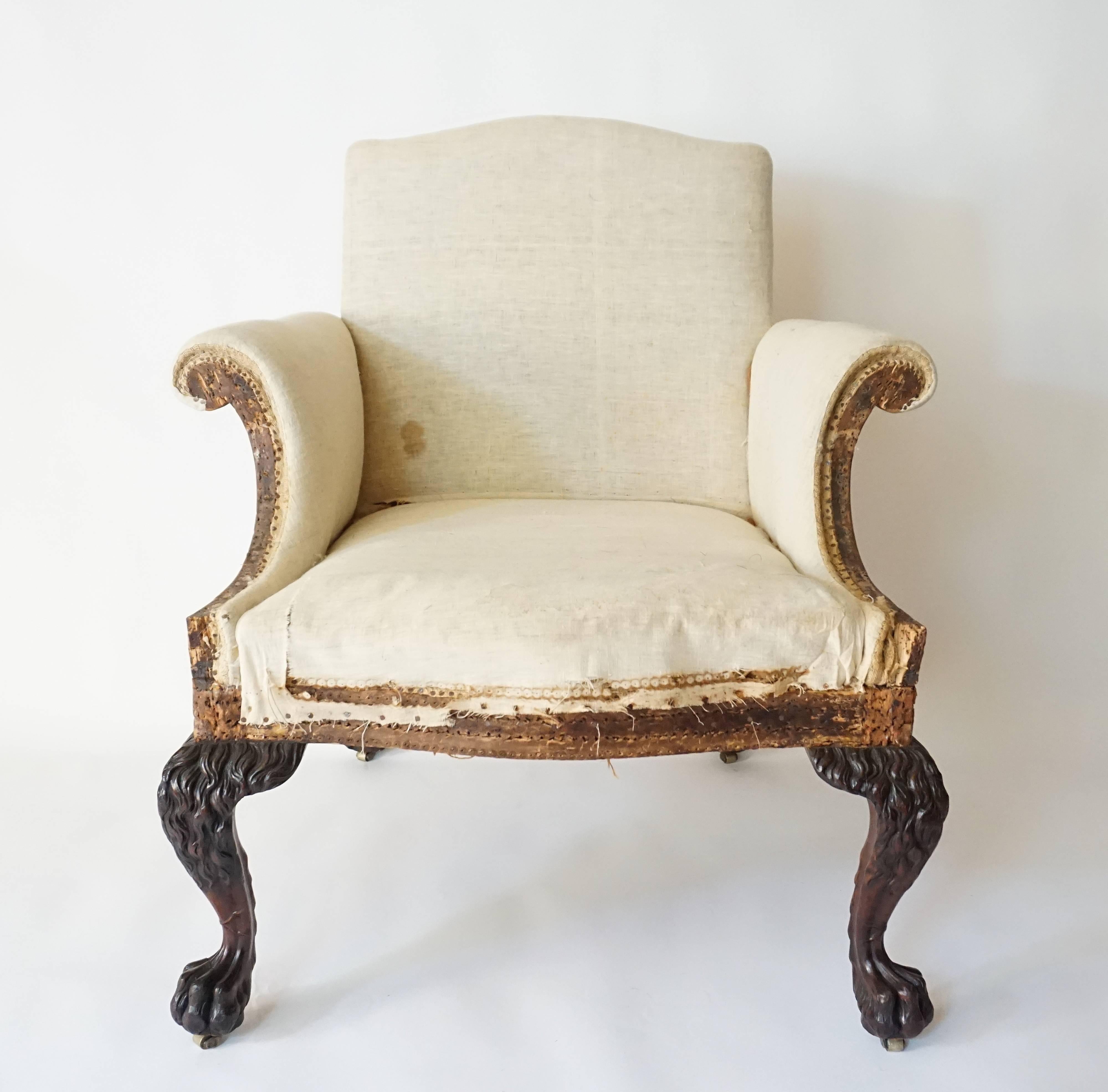 An important and exceptional circa 1905 George II style library armchair of large-scale by the renowned London firm of Lenygon & Company having upholstered 