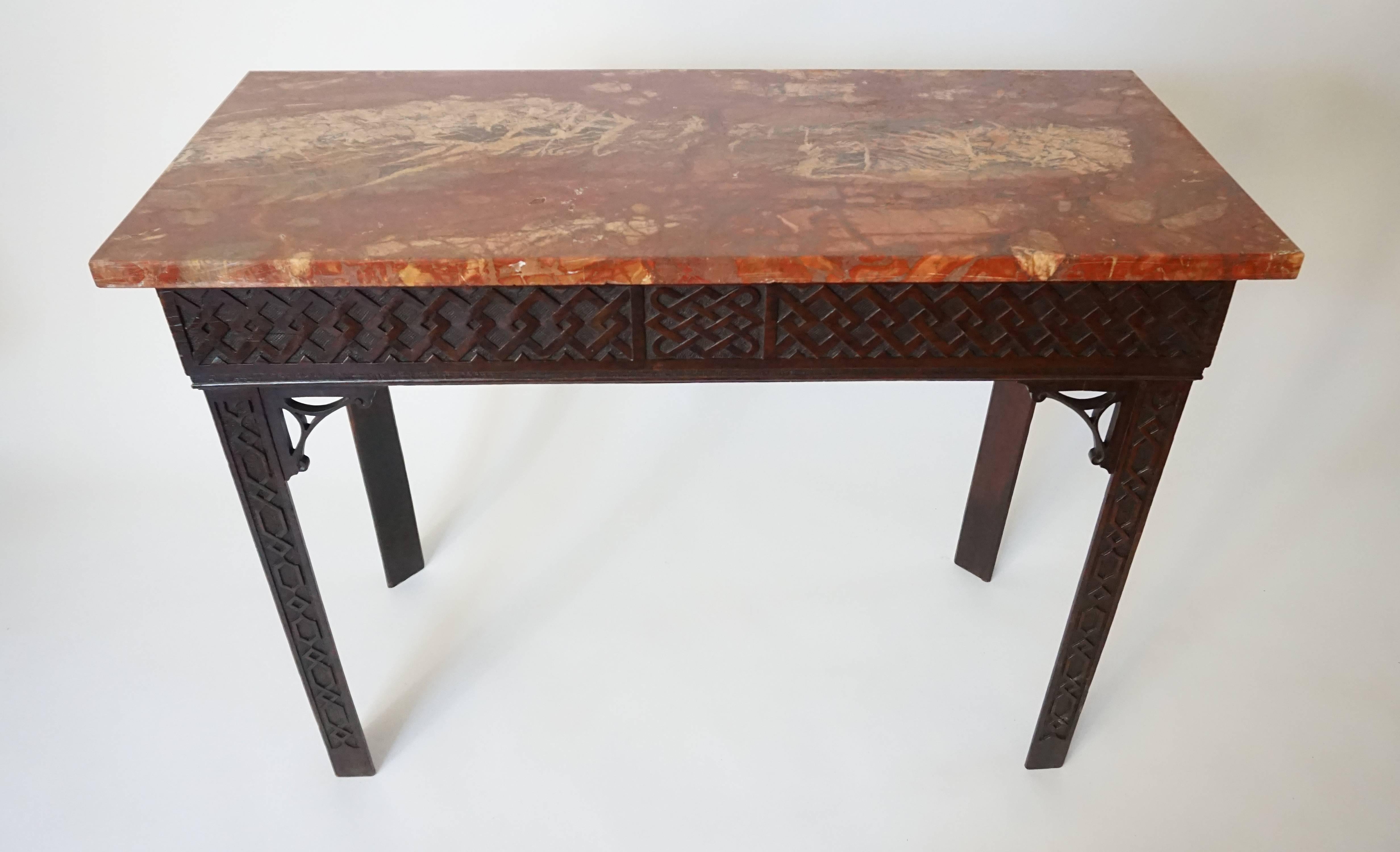 Exceptional circa 1760 Irish Chippendale mahogany slab or side table having breccia pernice marble top surmounting carved geometric interlacement band frieze with central carved 'celtic knot' reserve on triangular geometric chain carved legs with