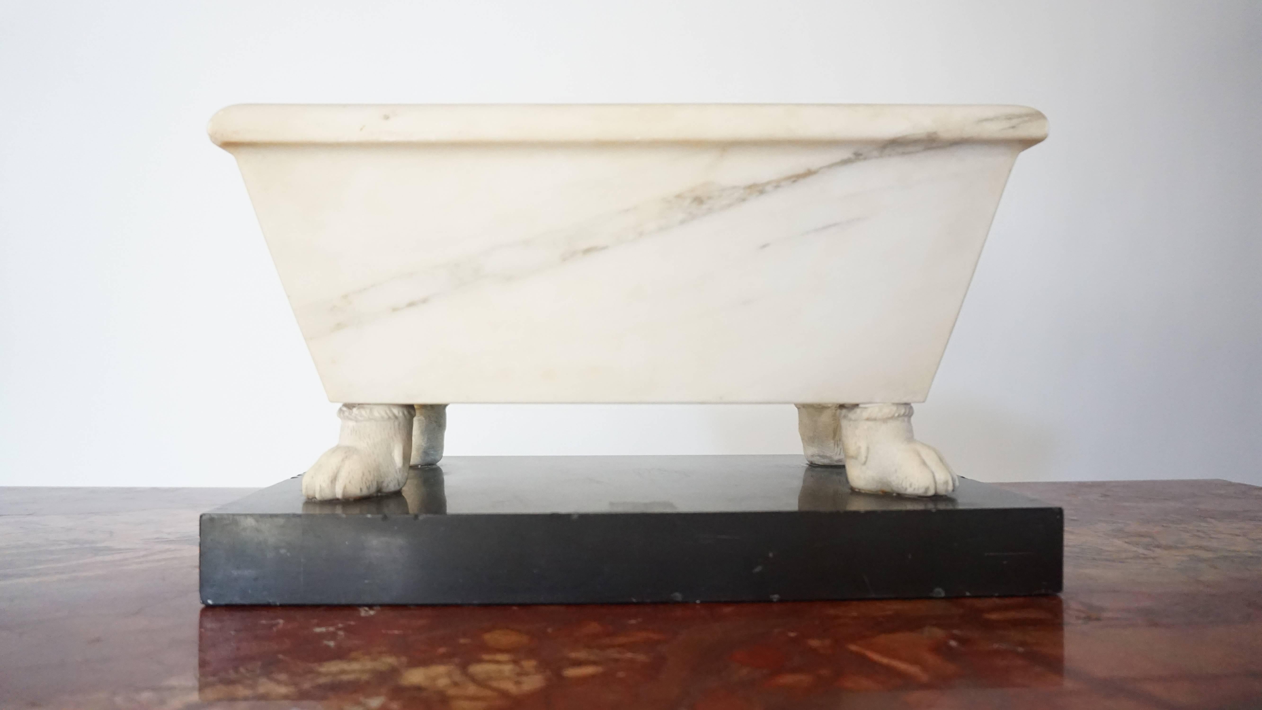 A rare and exquisite circa 1820 early Italian Grand Tour model of a Roman Lavacrum or 'bath' of unusually large size; the rectangular tub with tapering sides of carved solid Proconnesian marble (Marmo proconnesio) on delicately carved hairy paw feet