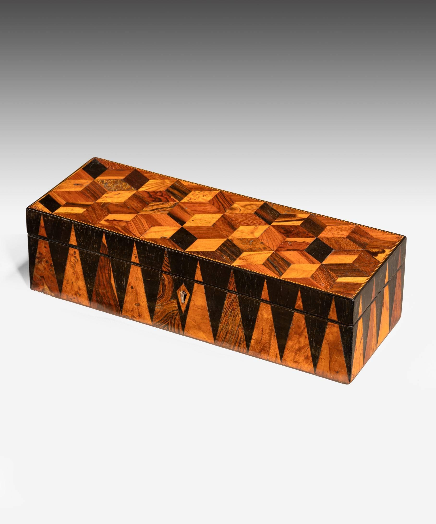 An early 19th century Tunbridge ware glove box; the lid veneered with perspective cube parquetry and the sides with Vandyke’s all executed in various specimen woods. Ideal for storing cuff links, watches, etc.