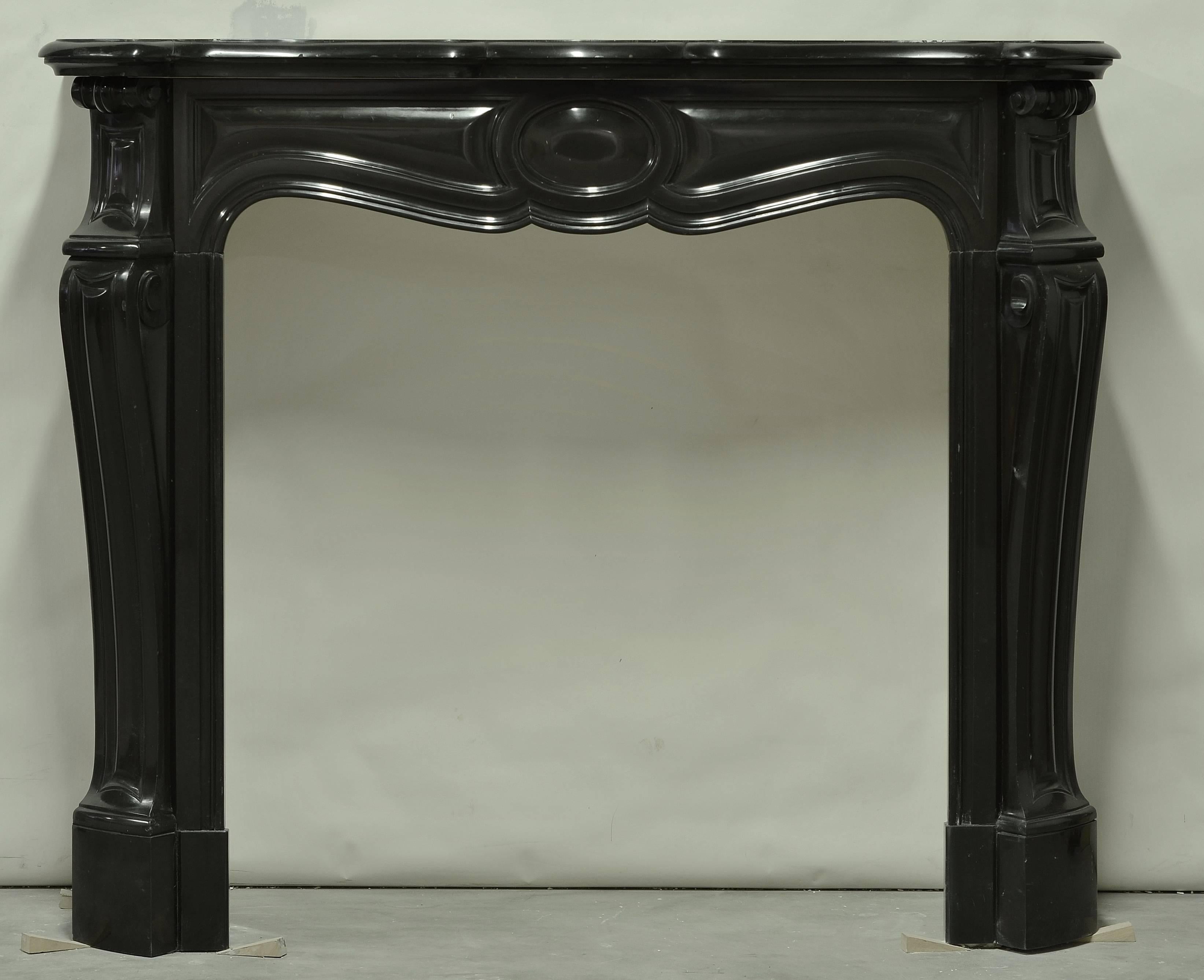 Very nice, original and decorative black marble Pompadour style fireplace. Comes with original porcelain insert,
19th century, France.

Opening measurements fireplace: 33 x 33 inch (height x width). 
Opening measurements insert: 21.4 x 23.8.

Crack
