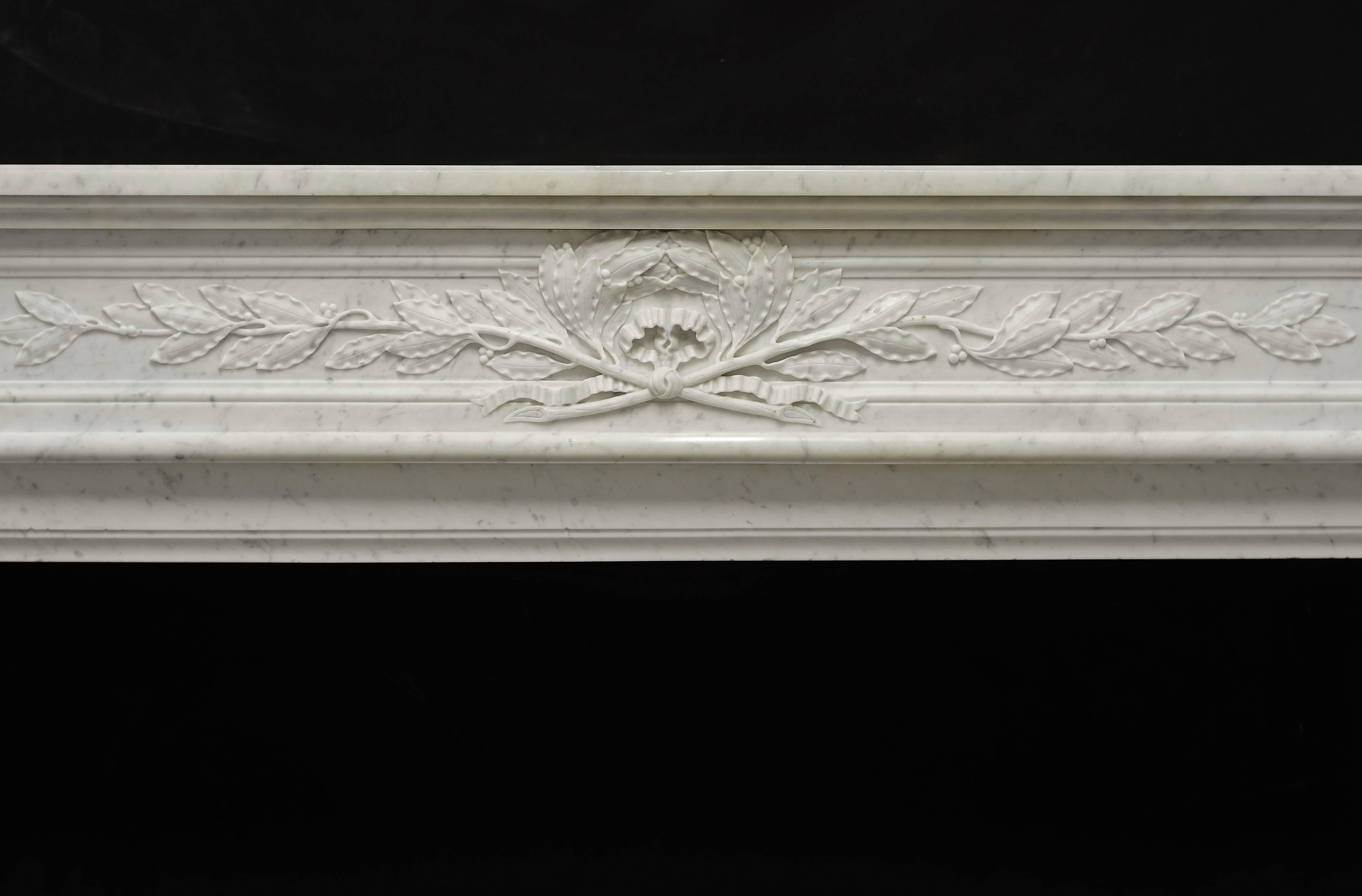 French antique Louis XVI fireplace mantel in white Carrara marble.

The finely carved paneled frieze with beautiful laurel leaves is flanked by square floral paterae.
Beautiful carved acanthus leafs and pearls on scrolled jambs.

Opening