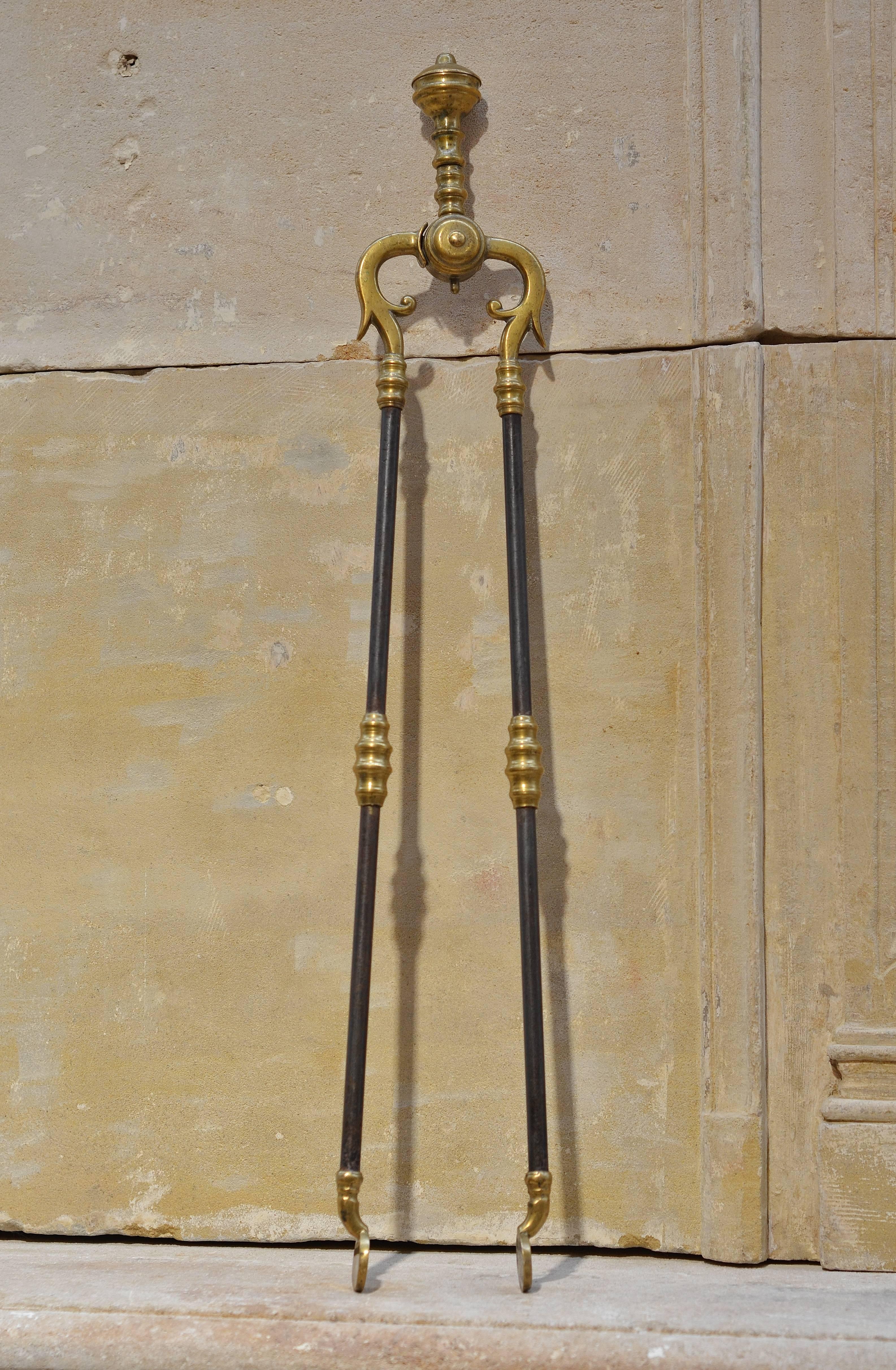 Very decorative trio of fireplace tools, the wrought iron core and brass decorations are in perfect condition.
      
  