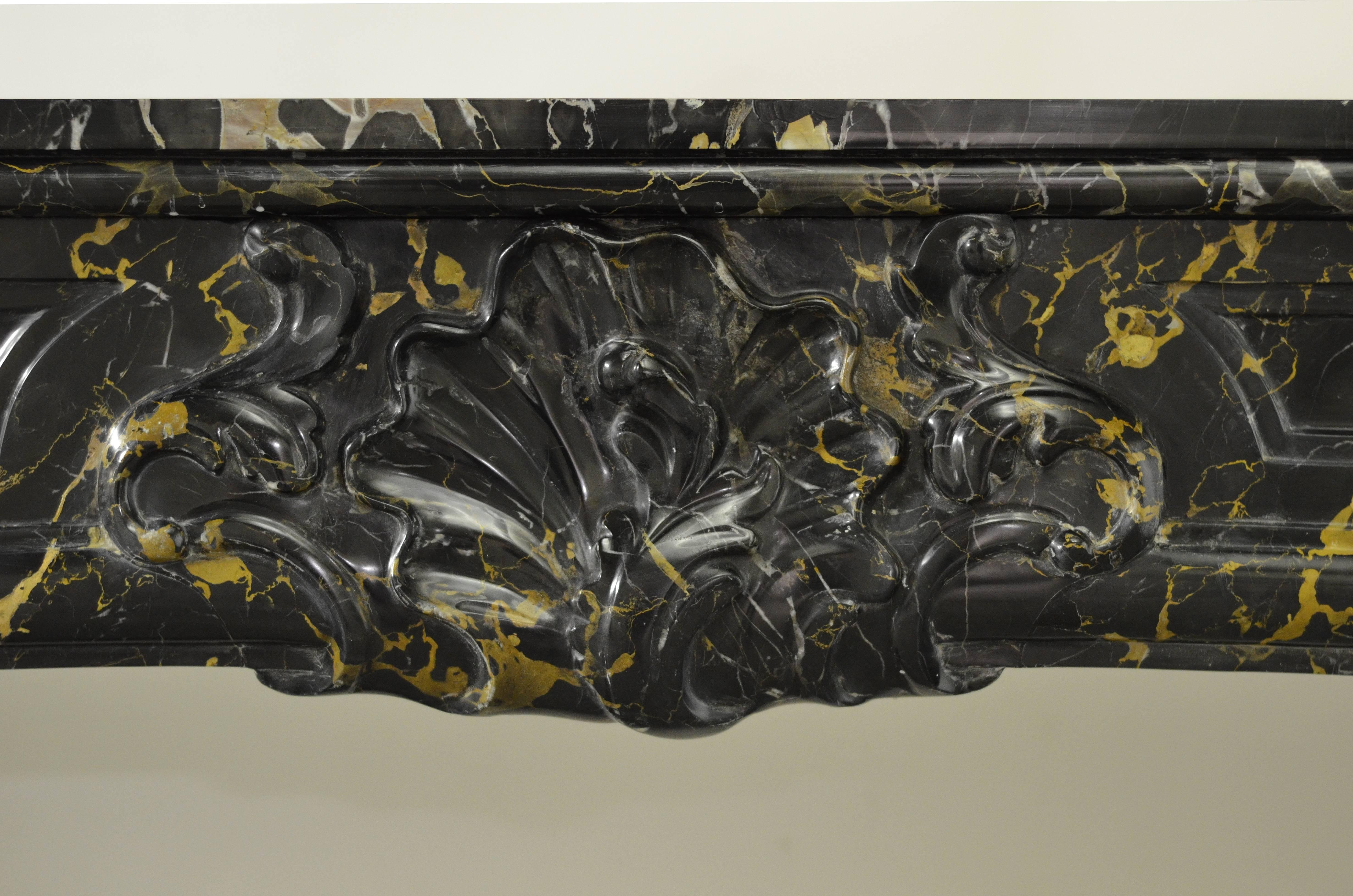 Beautiful 18th Century Dutch Louis XV fireplace. This mantel is executed in Italian Black and gold Portoro (port d'or) Marble.

Known provenance.
Restored, please ask.
Ready to be shipped and installed.