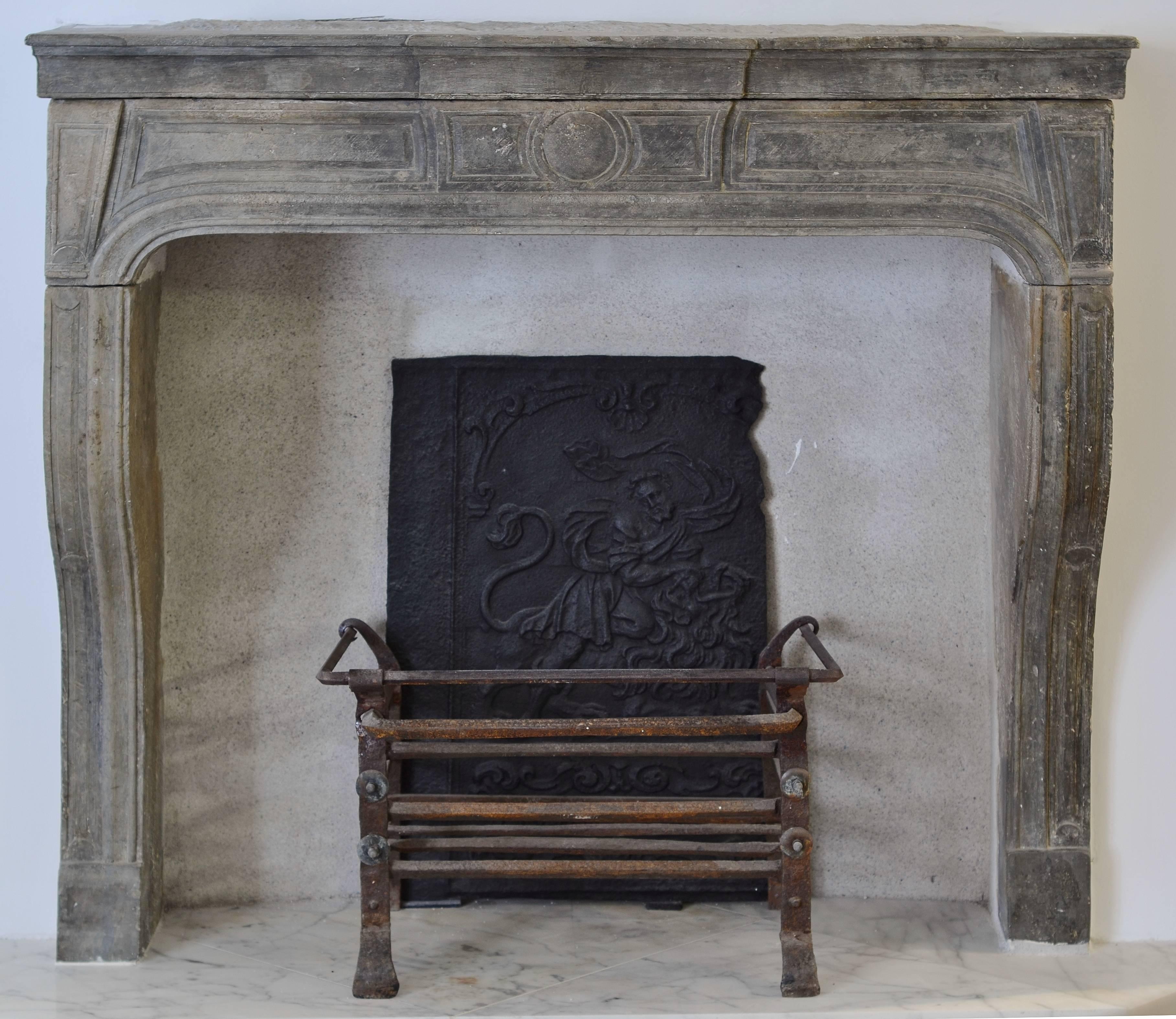 This unique late 17th century French limestone Louis XIV is very powerful in its purity. The simple yet impressive profile give it an unique sense of beauty. The warm shades of grey make it an exceptional mantelpiece that will enrich any