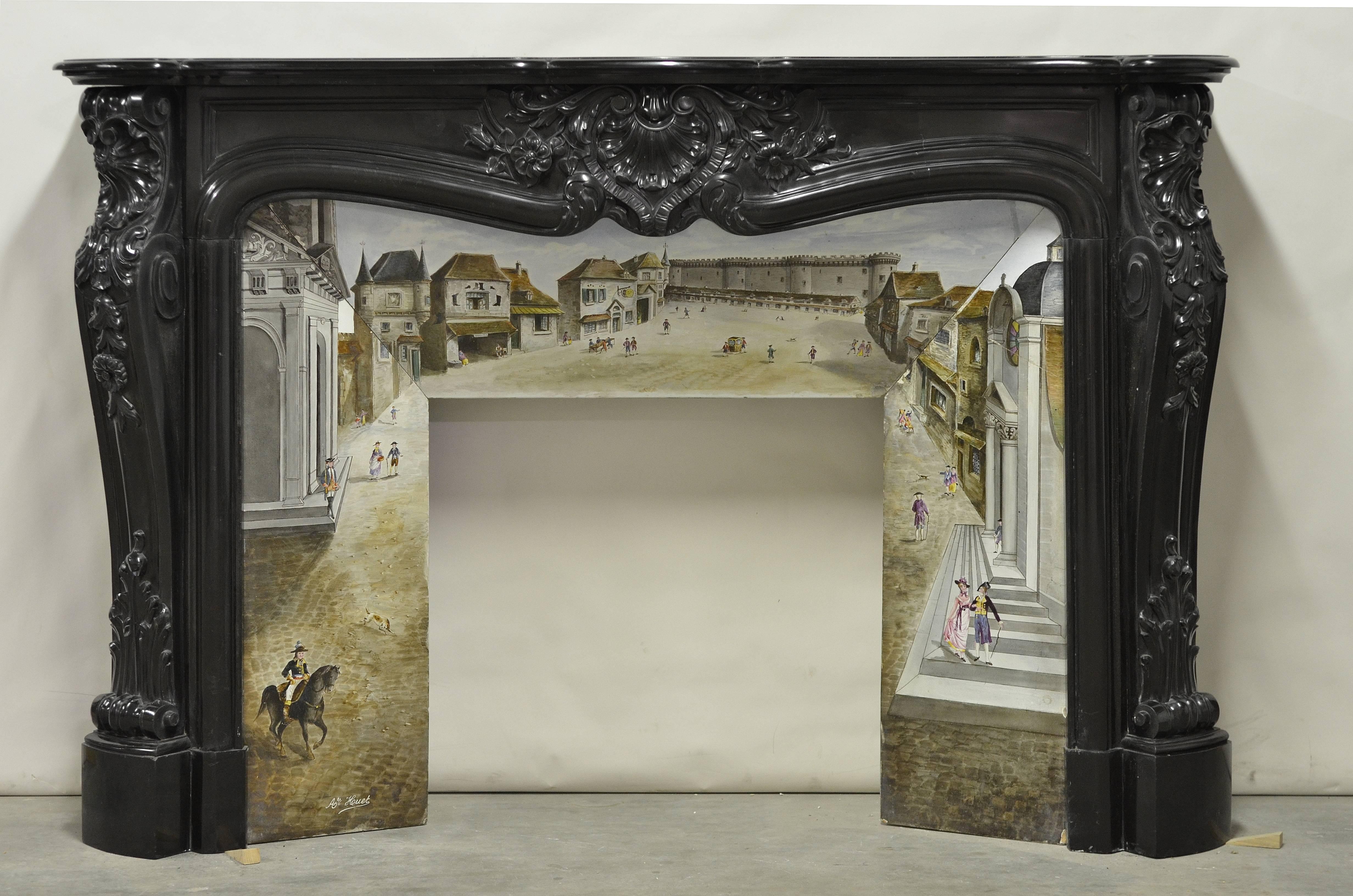 Impressive, beautiful and richly carved Louis XV fireplace from France, 19th century
This fireplace is executed in impeccable Belgian black marble.
The hand-painted porcelain insert displays a beautiful detailed town square, it is signed A'te