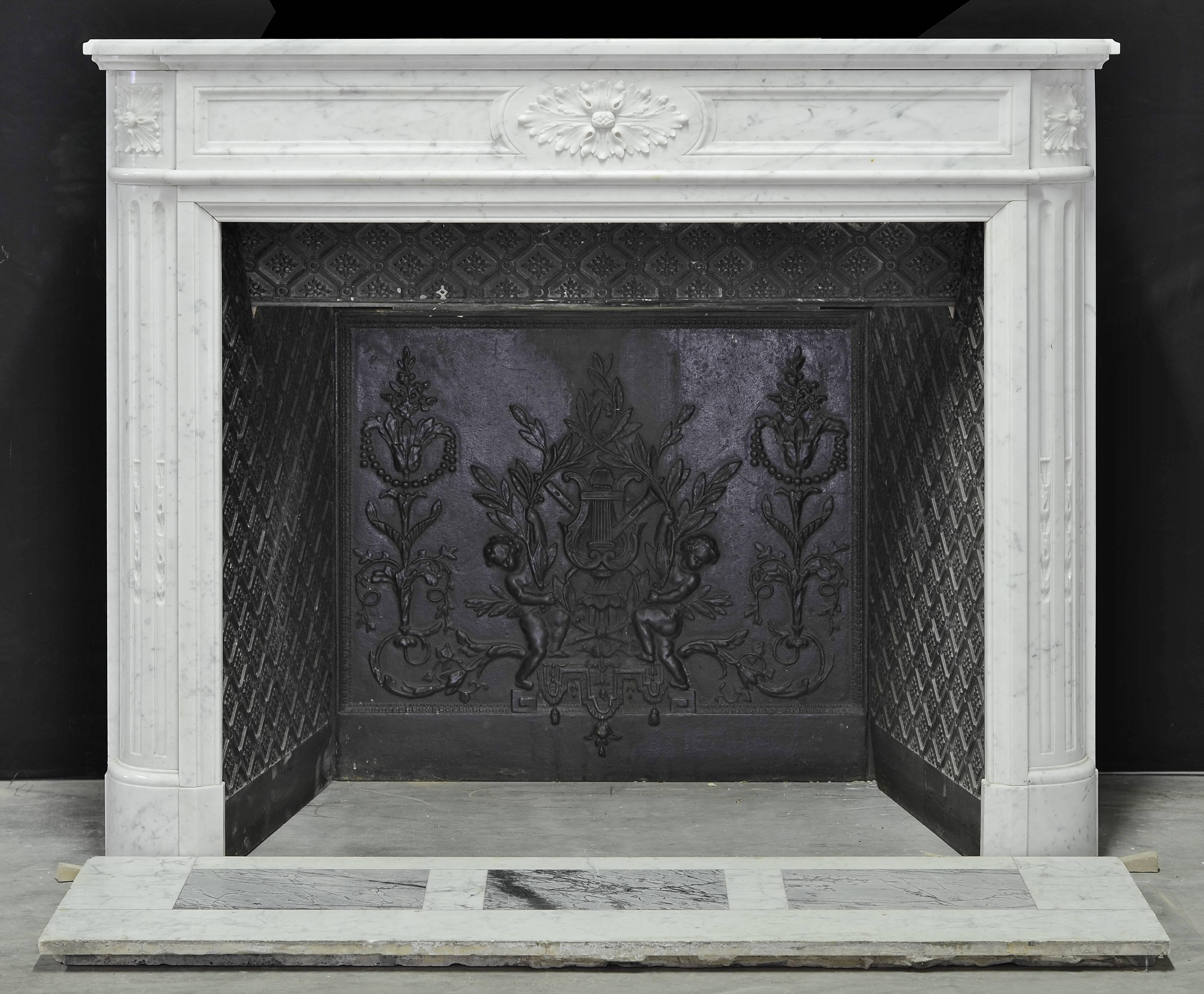 This beautiful and original Carara white marble French "demilune" Louis XVI fireplace comes with its original cast iron insert and marble floor.

The total fireplace package!

Opening measurements: 33.0 x 37.7 inch. (84 x 96 cm) height