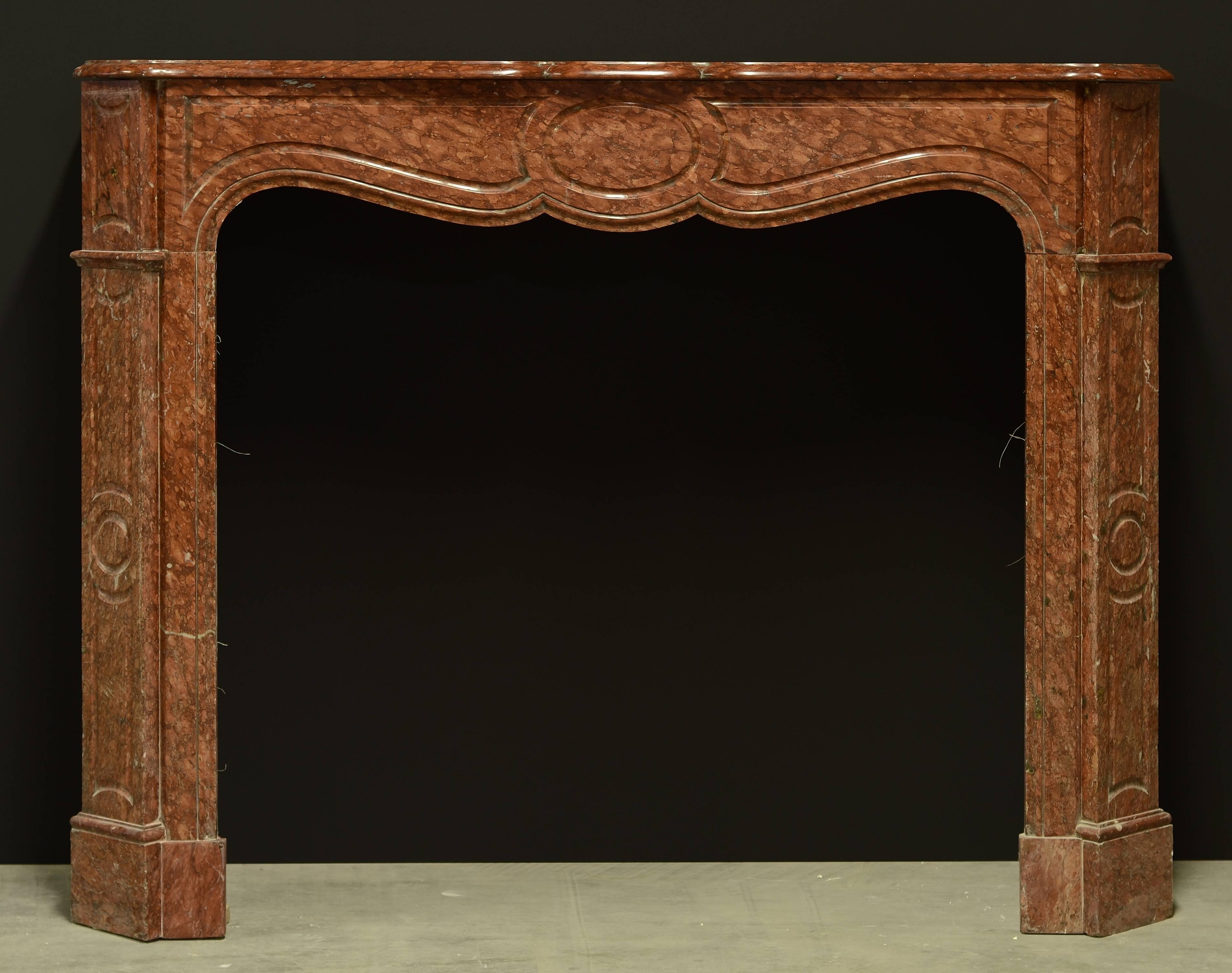 Warm red colored Pompadour style fireplace mantel from France, 19th century.
