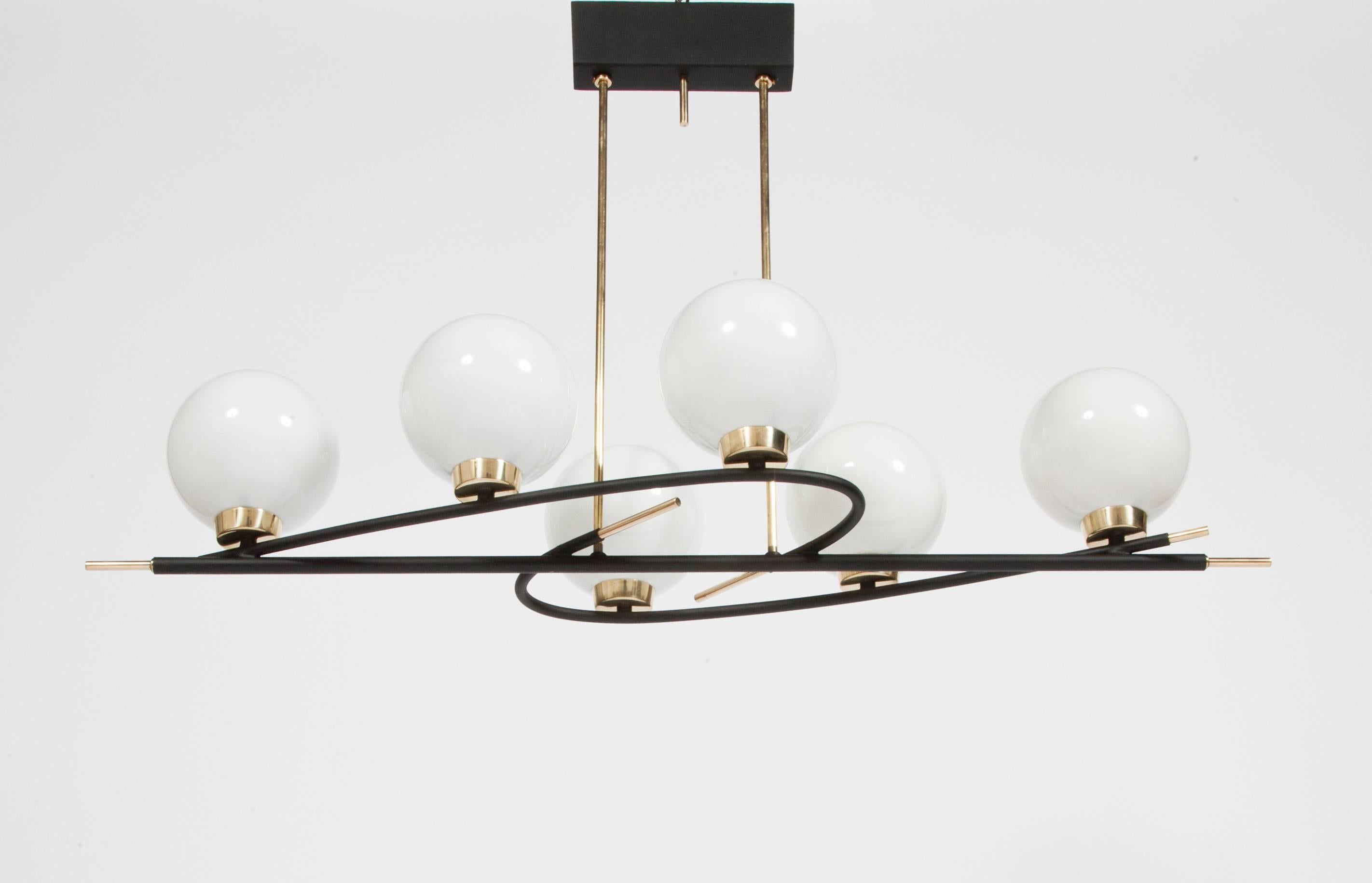 An elegant 1950s suspension light with six opaline glass shades resting on a twisted metal frame in painted metal and brass.
