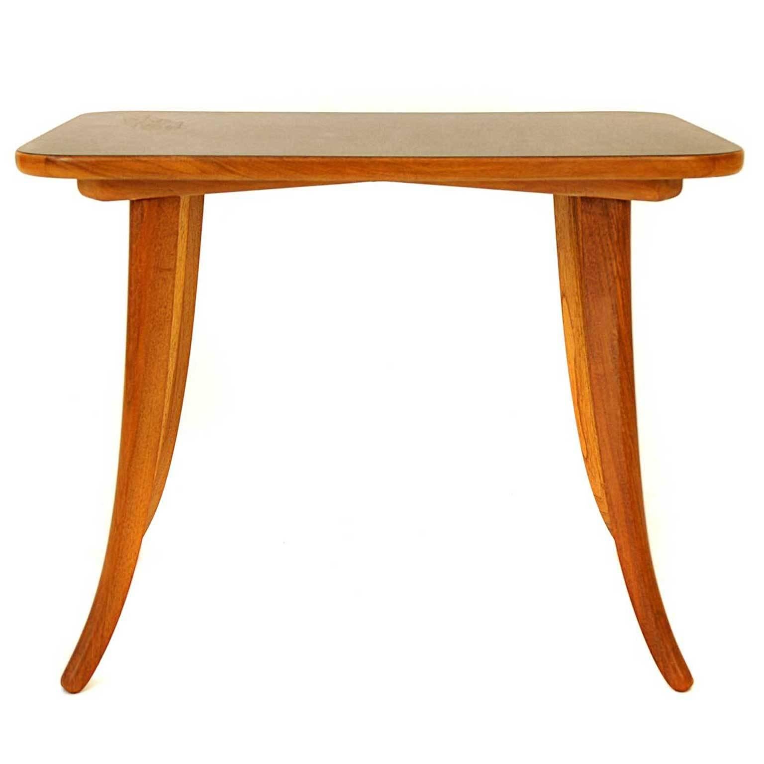 This coffee table was designed by Haus und Garden between 1925-1930. It is made of walnut with lacquered tabletop.