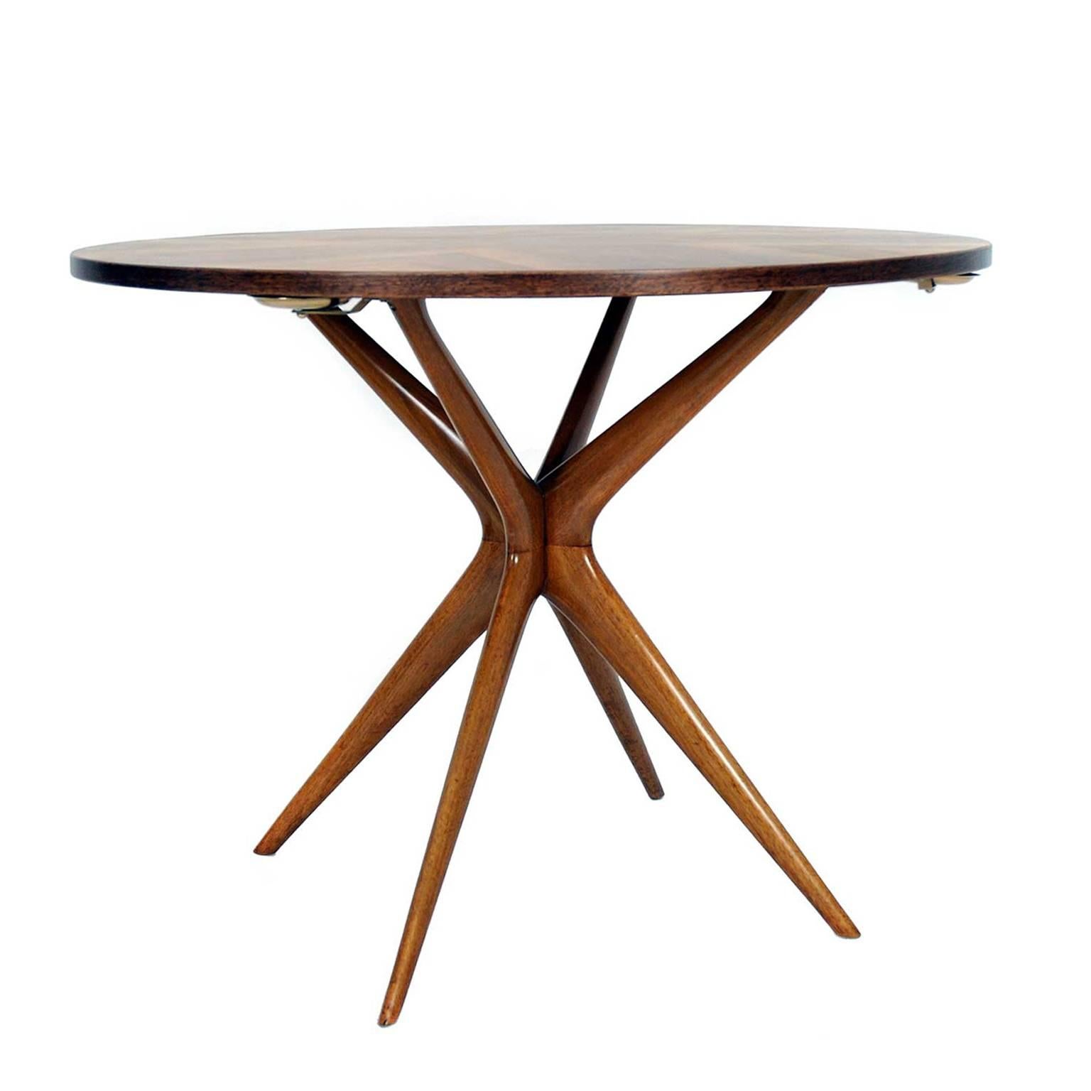 This piece was manufactured in Italy in 1950s. It is made of walnut. The table has five brass plates which can be hide under the tabletop. So it is possible to change the game table into a dining table.