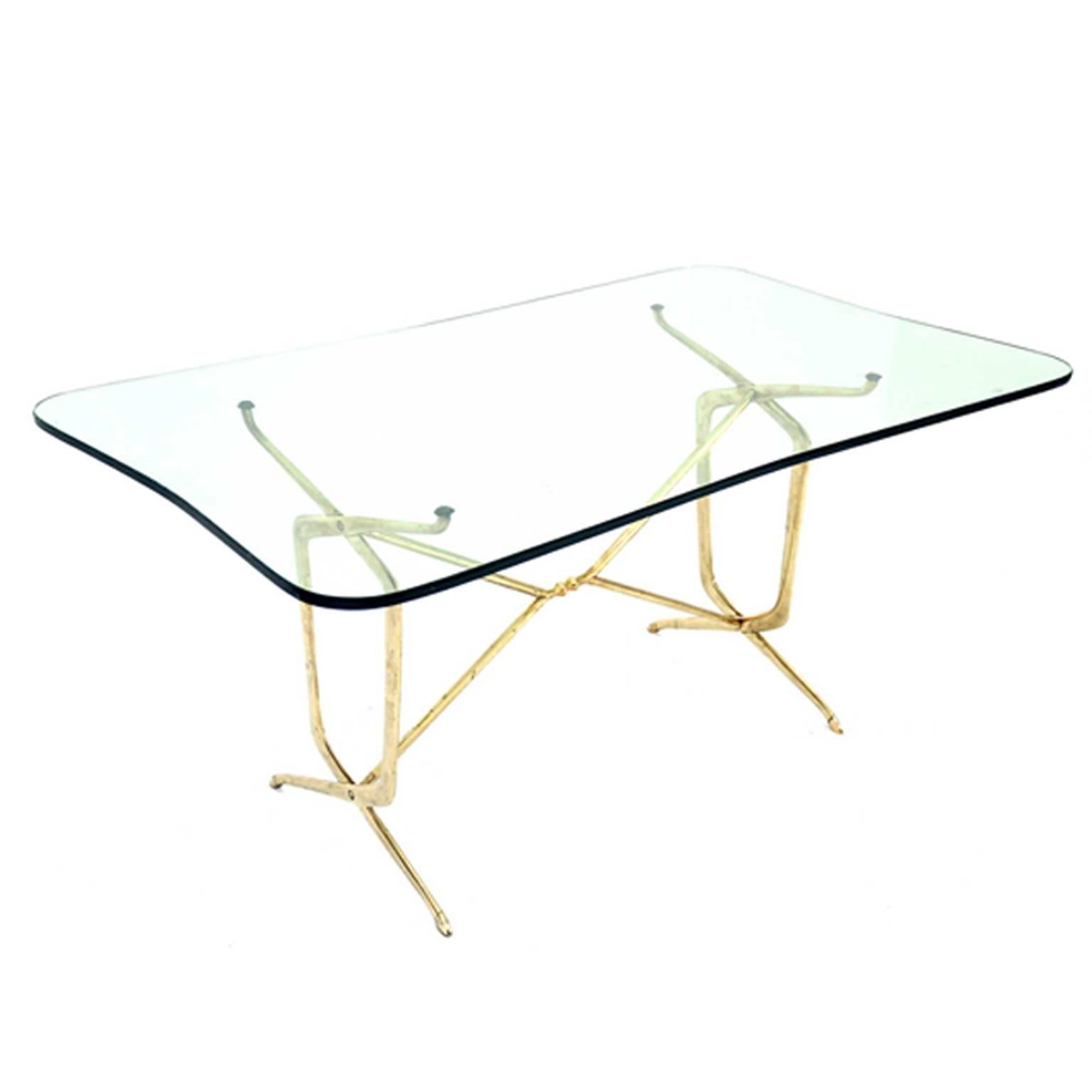 This piece was designed in Italy in 1950s. The rack is made of brass and the tabletop of glass.