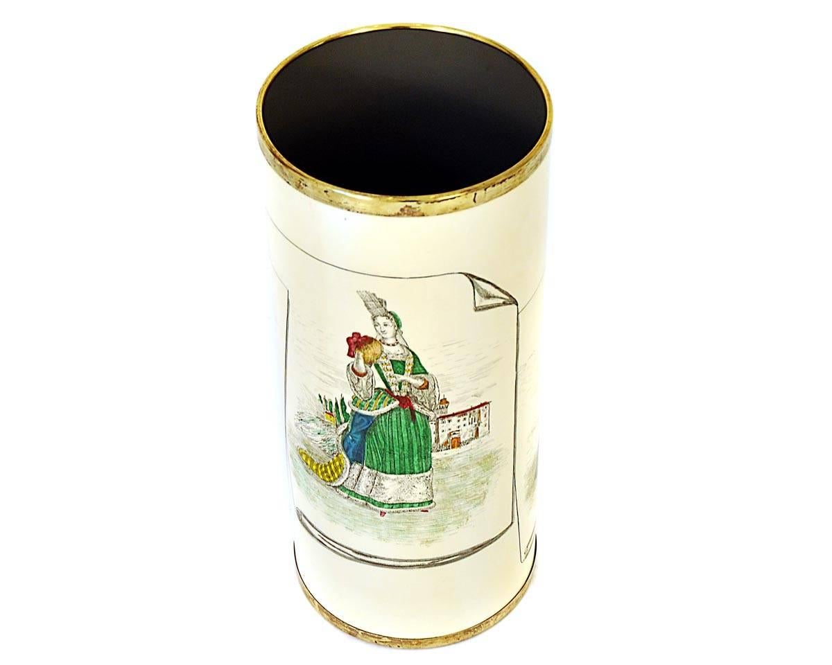 This umbrella stand was manufactured by Bucciarelli Milano in 1950s and the designer is probably Piero Fornasetti. The item is made of sheet and brass. The technique is serigraphy on sheet.