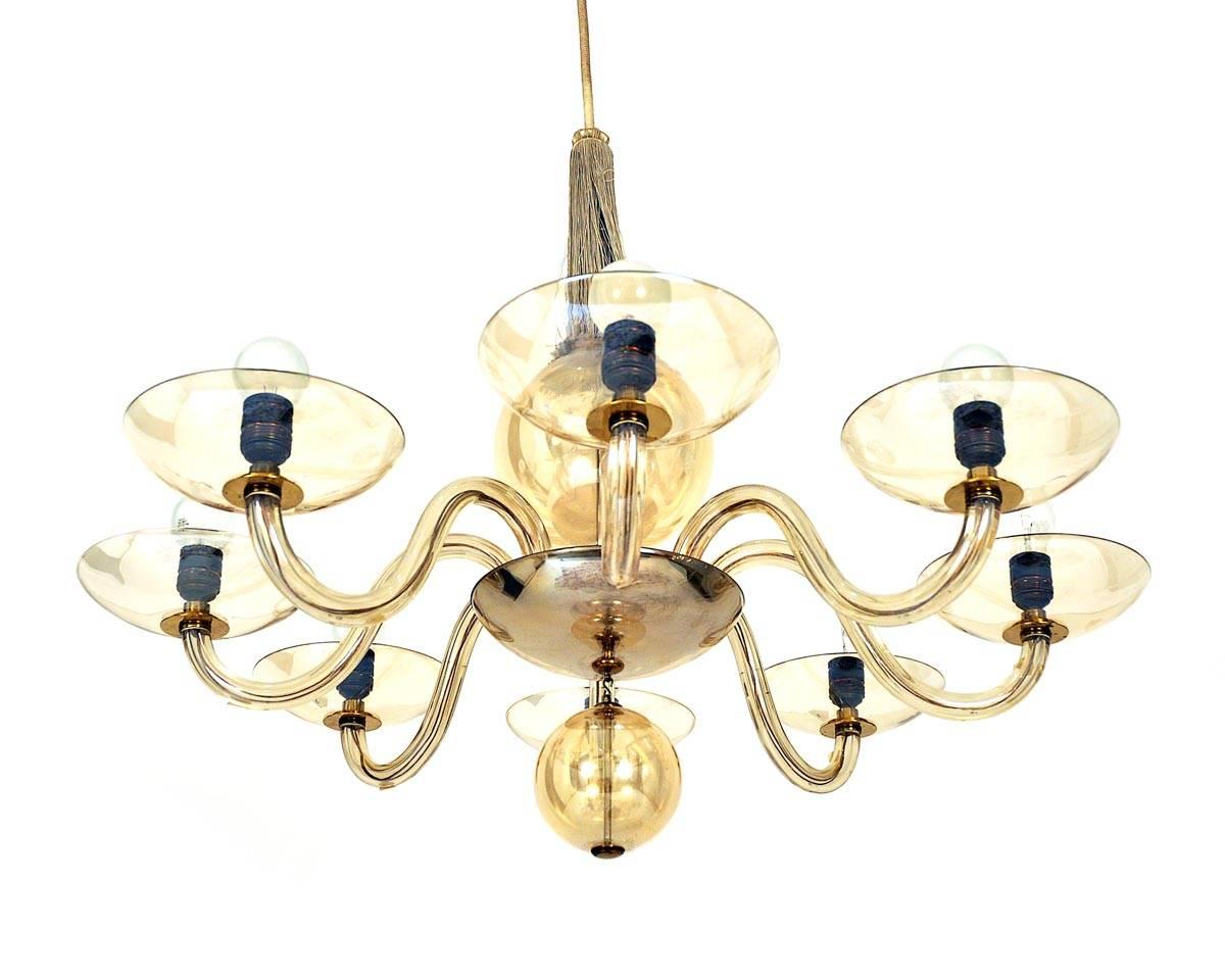 This chandelier was manufactured in Austria in 1920 by Lobmeyr. It is made of glass and brass. The chandelier has eight bulbs and it is in original condition.