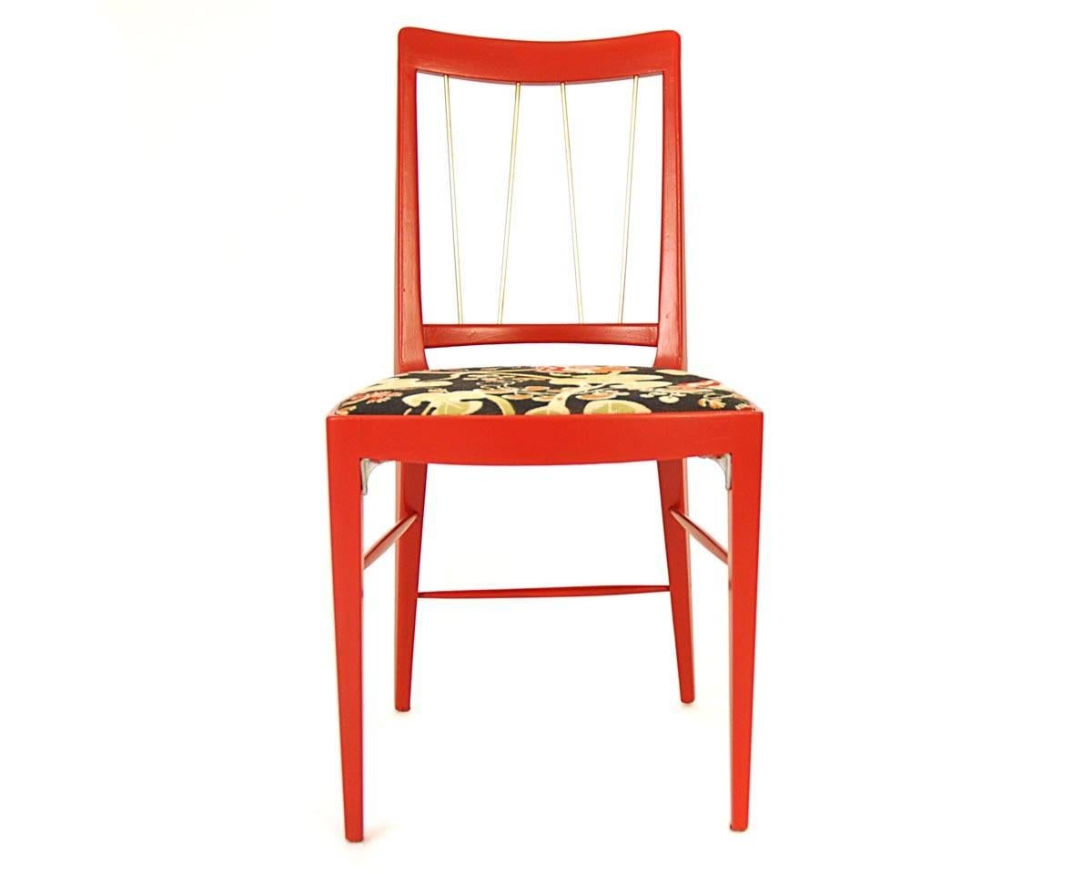 This chair was manufactured in Vienna in 1953 by Thonet and the designer is Oswald Haerdtl. The rack is made of beech and newly lacquered in red. The backrest has integrated brass staffs. The fabric 