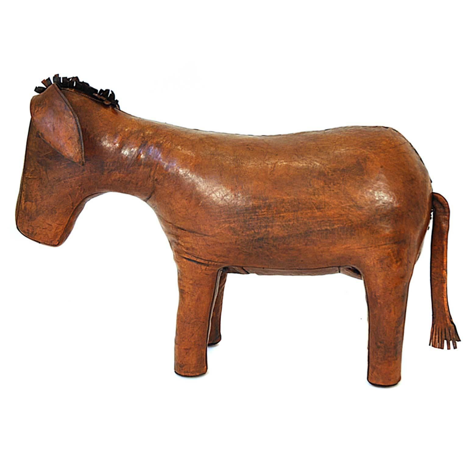 This piece was designed by Dimitri Omersa in 1960s (England). The donkey stool is made of cowhide leather with a metal construction inside and it is filled with hay. The series of stools representing various animals was marketed by Abercrombie and