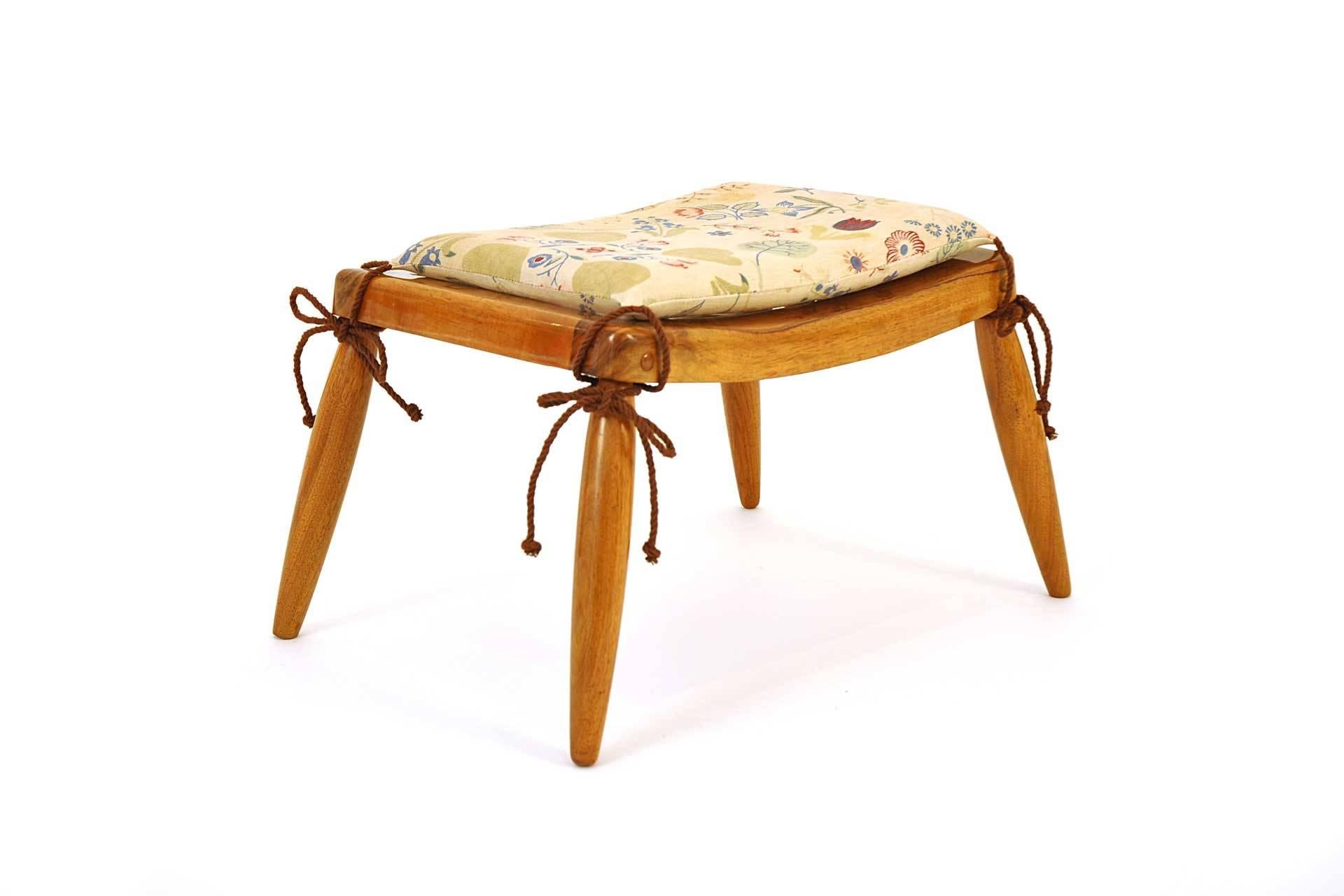 This stool was probably designed by Anna-Lülja Praun in 1930s. The furniture frame is made of walnut and polished. The seat has steel springs and loose hassock. It has also new upholstery.