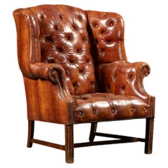 Poltrona Chesterfield con schienale ad ali in vinile trapuntato, colore marrone