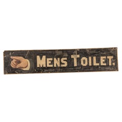 Cartel antiguo y pintado a mano que indica la dirección del baño