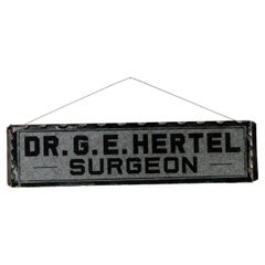 Antique "Dr. G.E. Hertel, Surgeon" Foil-Backed Scalloped-Edged Glass Sign