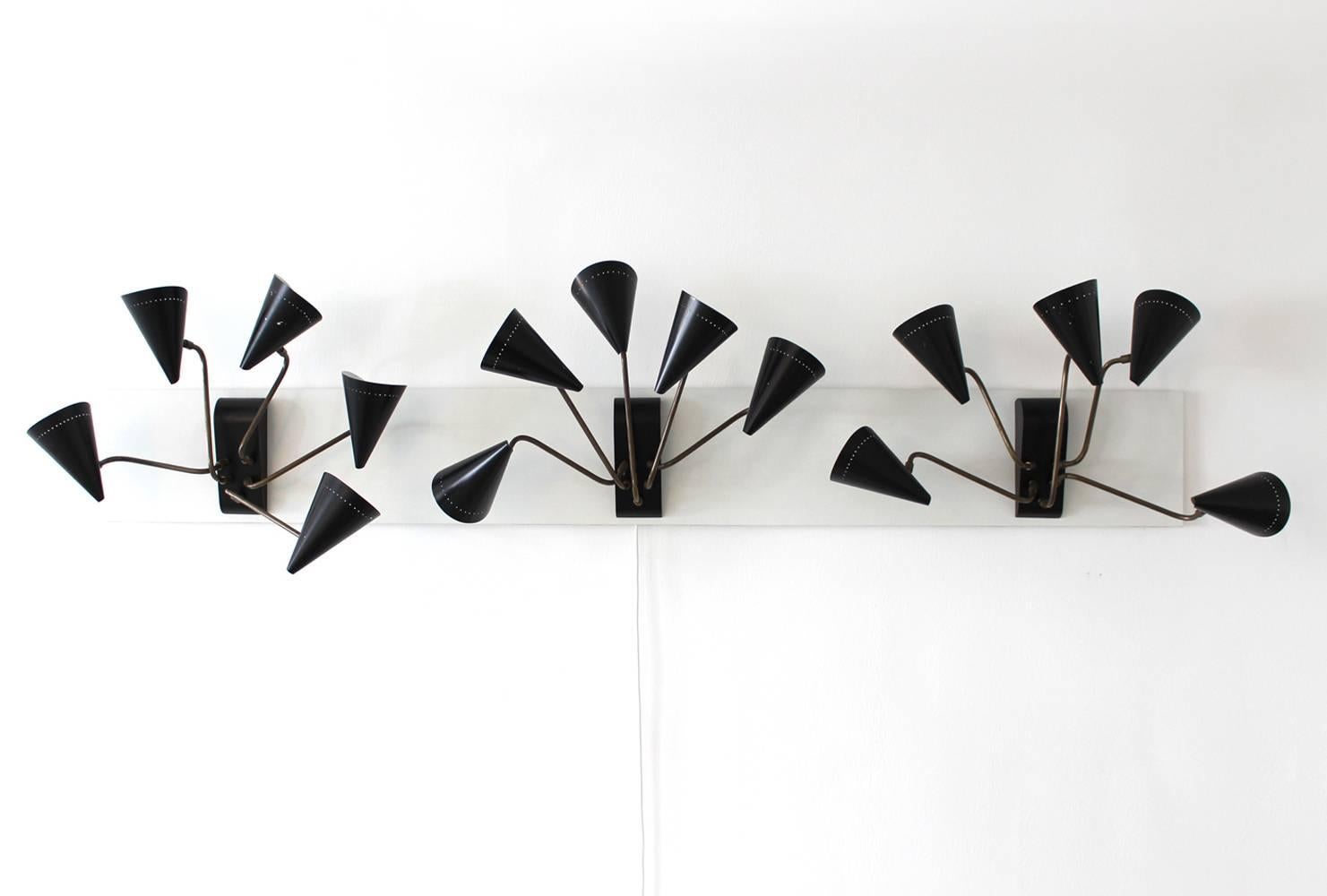 Amazing set of three French wall lamps from 1950 in the style of Royere
Each lamp has a black lacquered metal base with five movable arms.
The 15 movable arms can be turned in different directions and angles, the lamps can be changed in various