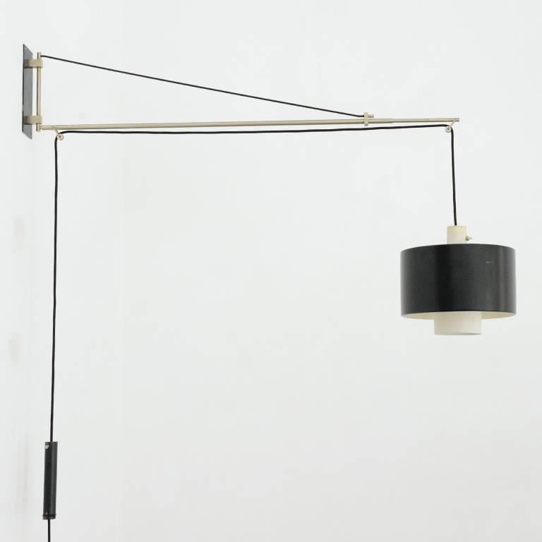 Rare wall arm lamp edited by Stilnovo in 1957.
The wall arm swivels 180 degrees and is extendable up to 140cm.
The height of the lampshade is adjustable as well by simply pulling the counterweight.
The on/off switch is integrated in the lampshade.