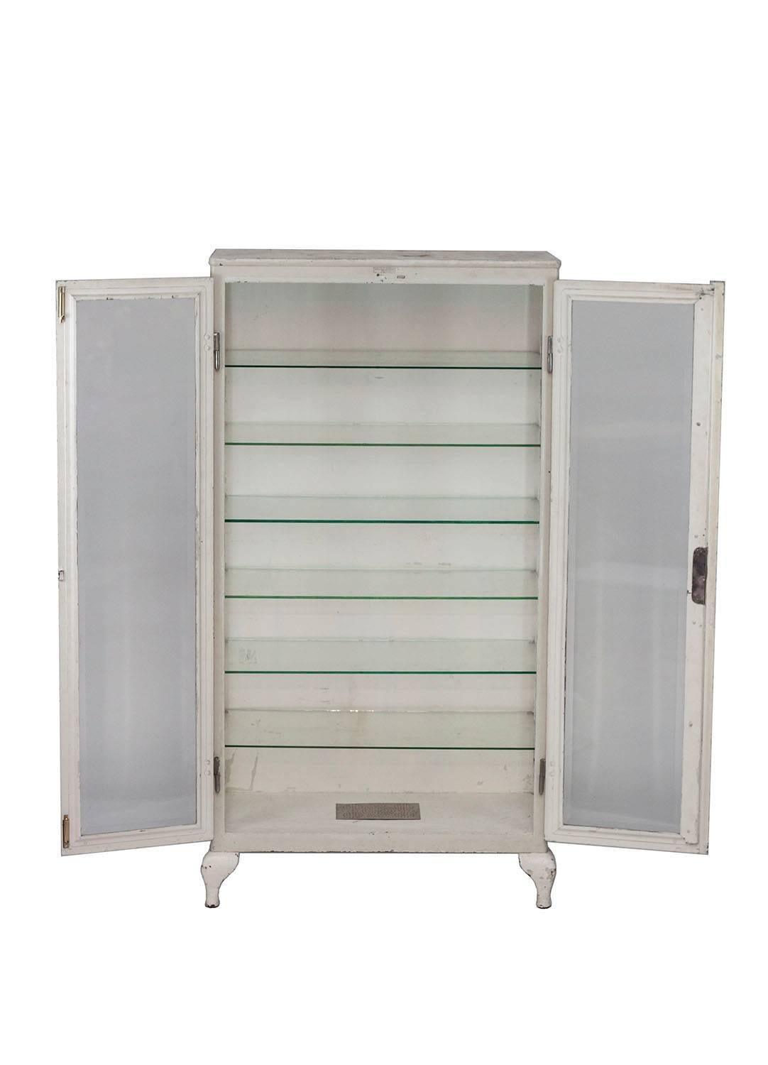 Large vintage Industrial cabinet with six adjustable glass shelves. Perfect storage solution for a bathroom or to display curiosities. The cabinet also has a key for the lock.