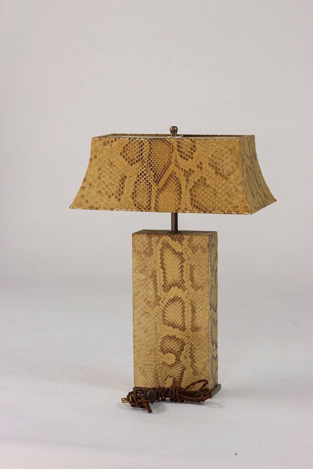 Exceptional table lamp in bronze, with base and shade both covered in python, designed by Karl Springer. Rewired for immediate use.

Karl Springer (1931-1991) was born in Germany and emigrated to America to begin a career as a bookbinder at Lord