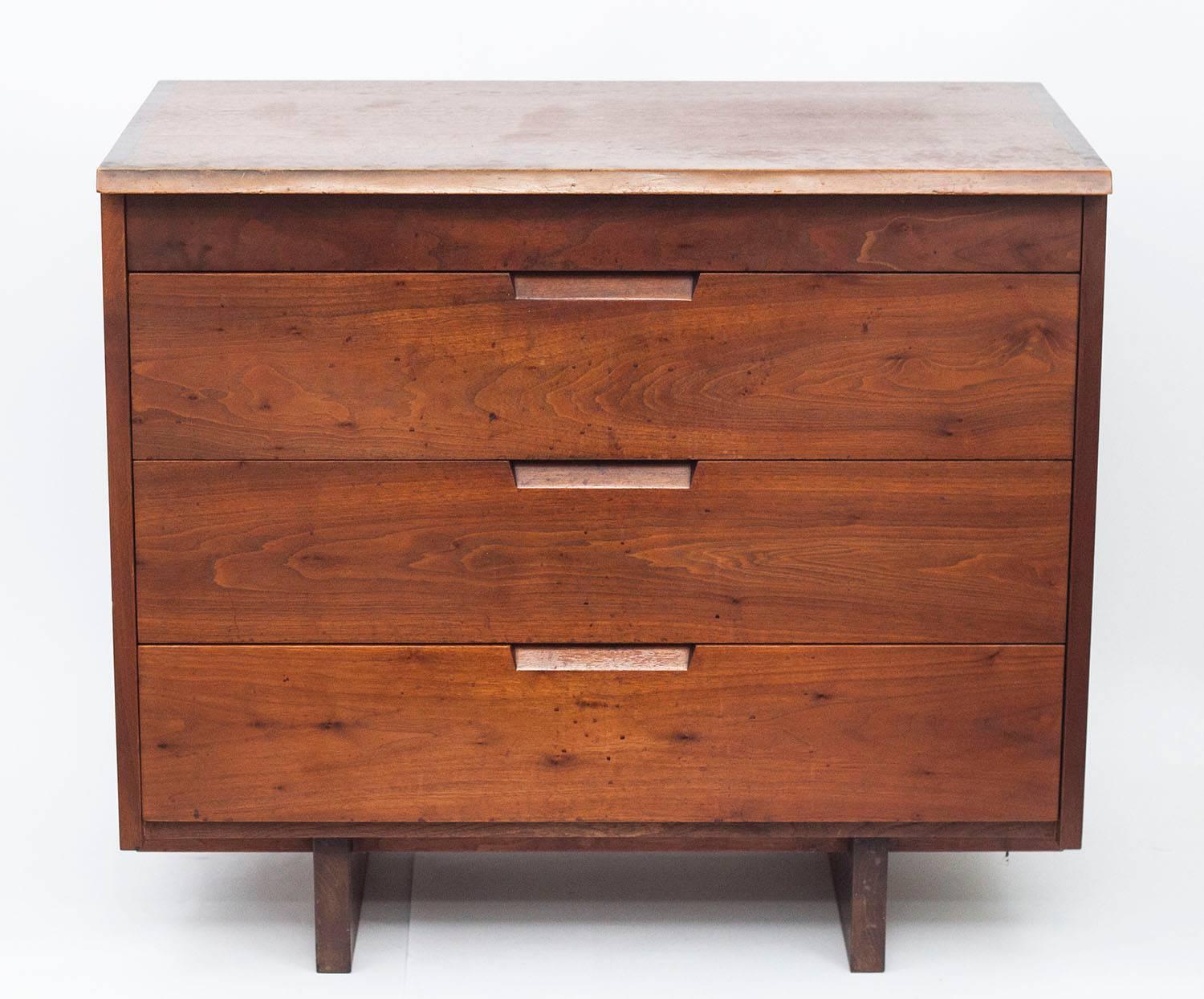 Pair of quintessential Nakashima walnut dressers showing featuring dovetail construction and a natural edge. These dressers were crafted in his historic workshop in New Hope, PA in 1963 and are signed with the client name.

George Nakashima