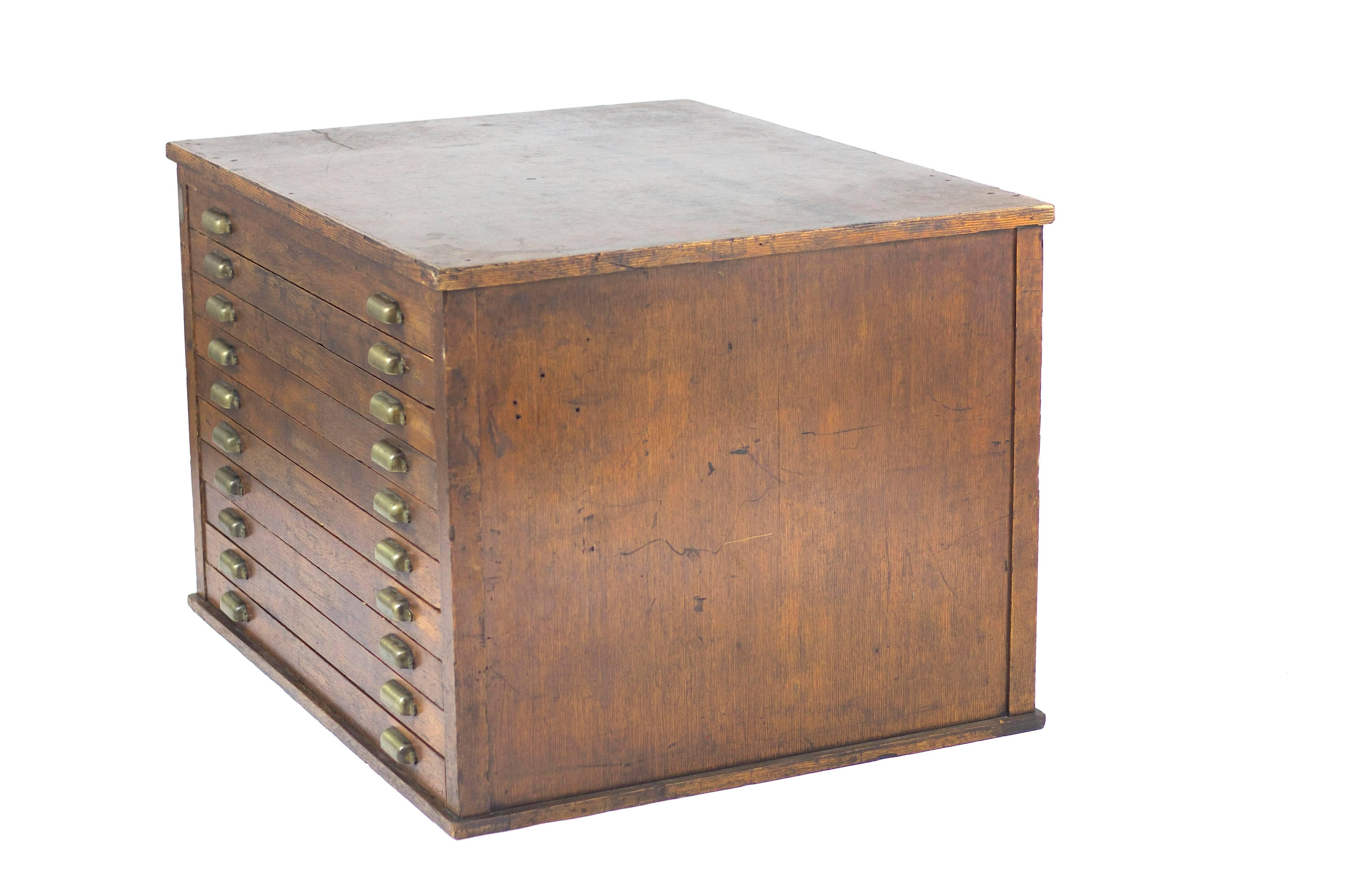 1930s, American.
Vintage ten-drawer oak flat file cabinet. Beautiful original patina. Rare and striking, completely refurbished including the hardware. Perfect for storing blue prints, drawings, plans, artwork, etc.
 