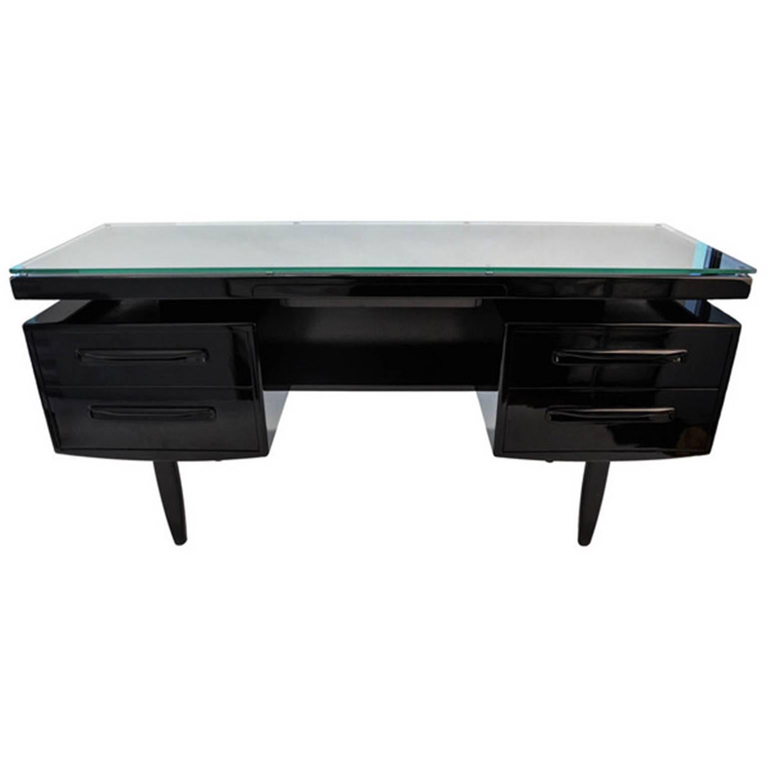 Beautiful 1970s lacquered Danish Bureau desk. It is in the colour black, with glass top and five draws.
