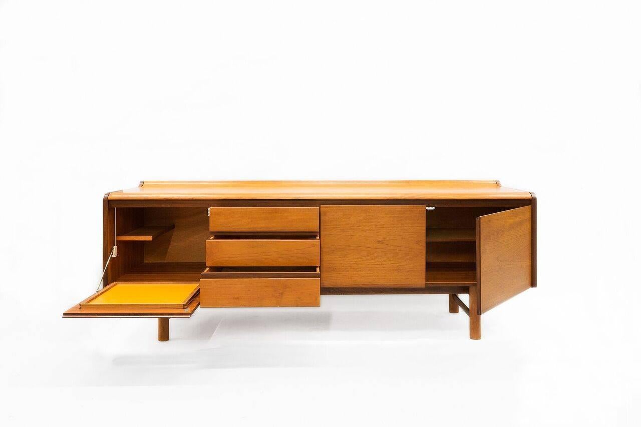 A fabulous example of a 1970s teak side cabinet, with a wonderful combination of curves and angles.