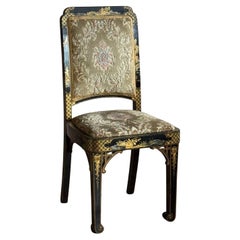 Antique black and gold lacquered chinoiserie dining chairs.