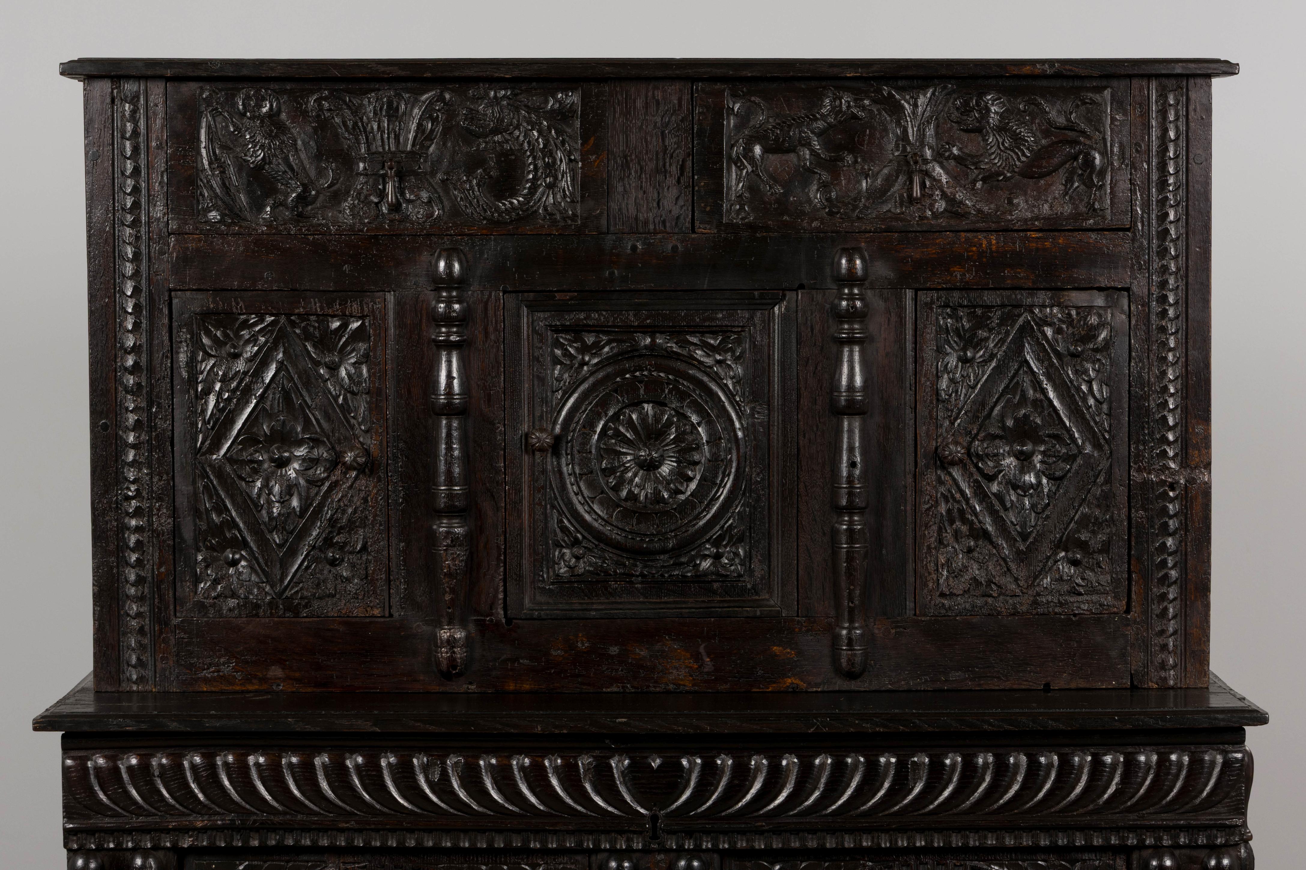 Un eccezionale mobile rinascimentale francese del XVIII secolo, proveniente dalle Alpi francesi. Realizzato magistralmente a mano in legno massiccio di quercia, questo ensemble di due pezzi presenta intagli squisiti ed elaborati, emblematici