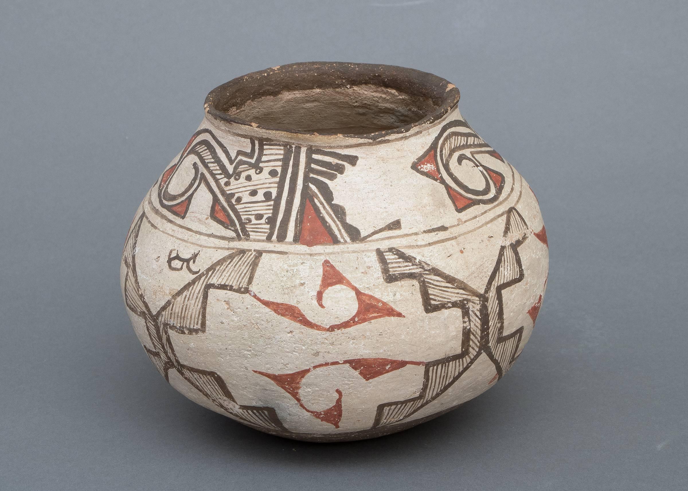 A polychrome jar painted in slip glazes with Classic Zuni geometric design elements in dark-brown and red on a white field.

Messenger Service is available to the Denver & Boulder metro areas as well as other select destinations within Colorado. 