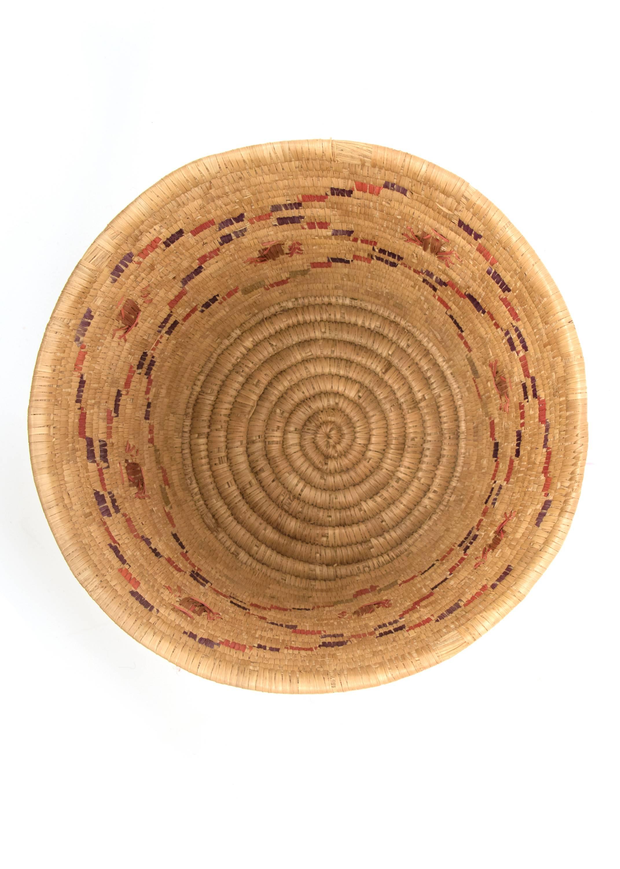 Inuit/Eskimo Pictorial Polychrome basket, first quarter of the 20th century.

Straight sides, bundle coiled with embroider style beetle motifs in brown floating within a lattice design in red and purple.

The Inuit territory includes northern