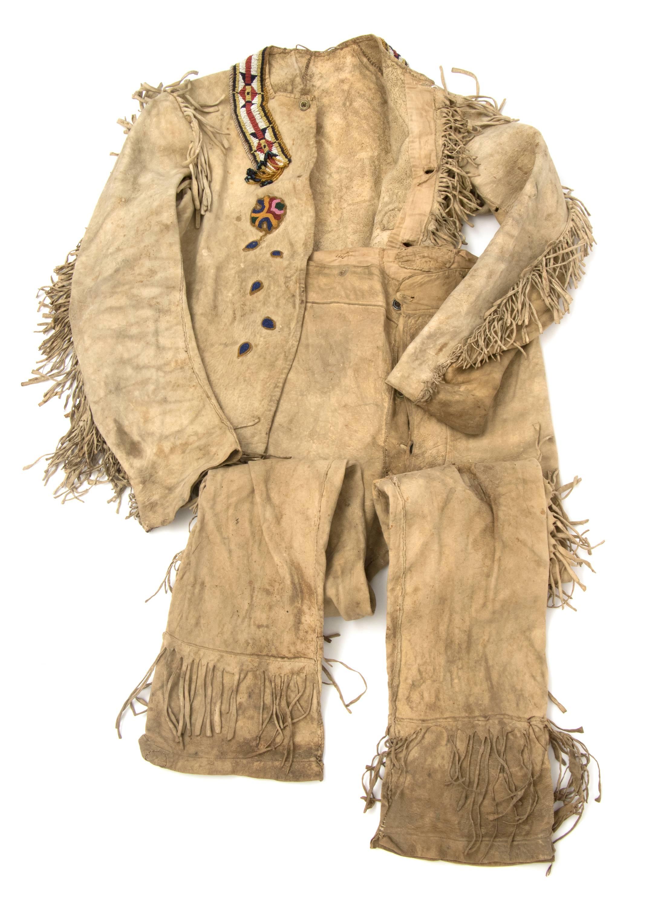 An authentic vintage Native American (Plains Indian) outfit with  jacket and pants constructed of native tanned hide and fringed. The jacket is beaded in traditional designs. At the time these were created, the Ute inhabited parts of present day
