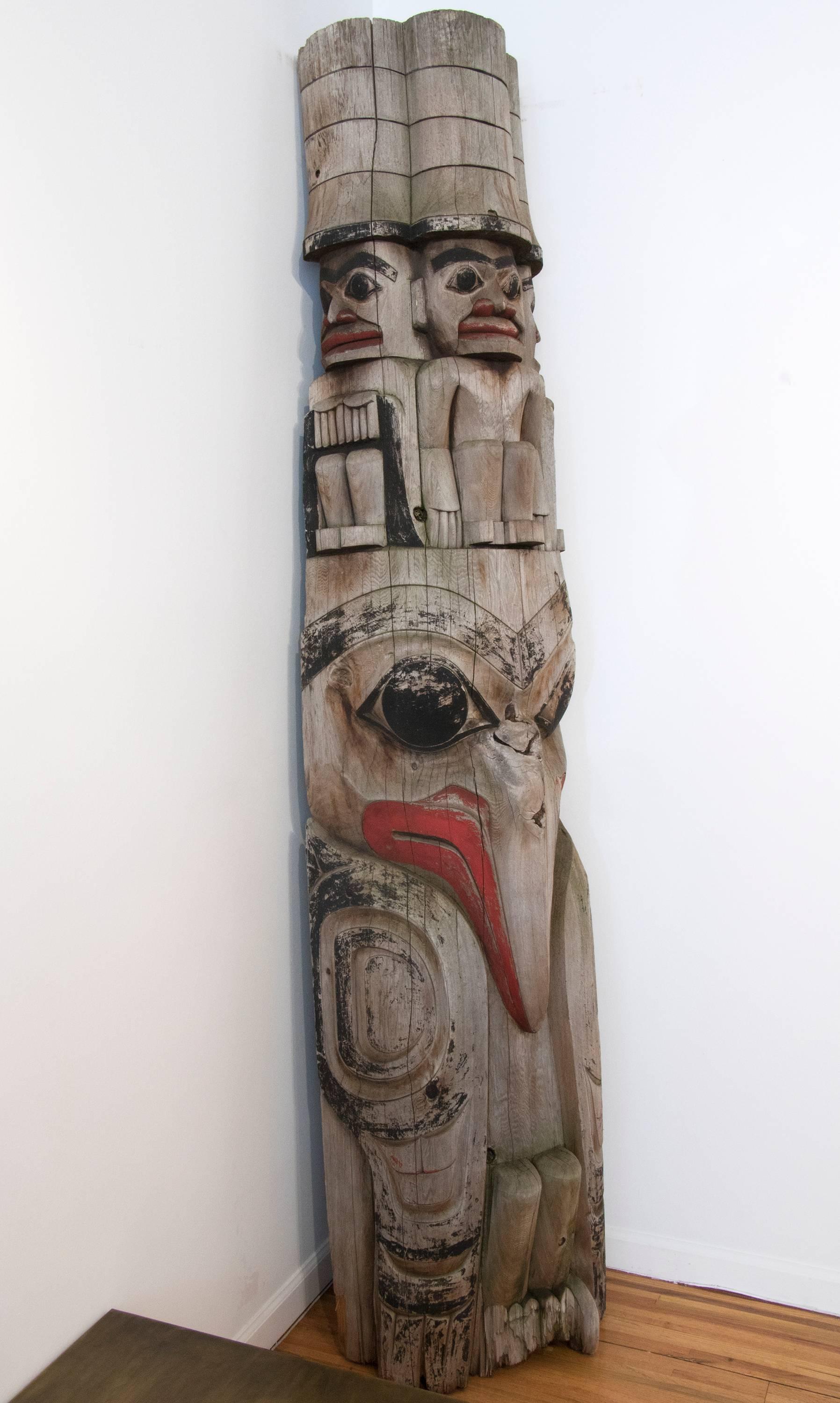 Likely a segment from a full TOTEM pole. It stands over 7 1/2 feet tall and is 20 inches wide and 16 deep. It has been outside and has a lovely weathered patina.

Expertly carved and painted by a Tlinget carver. The Tlingit peoples are indigenous