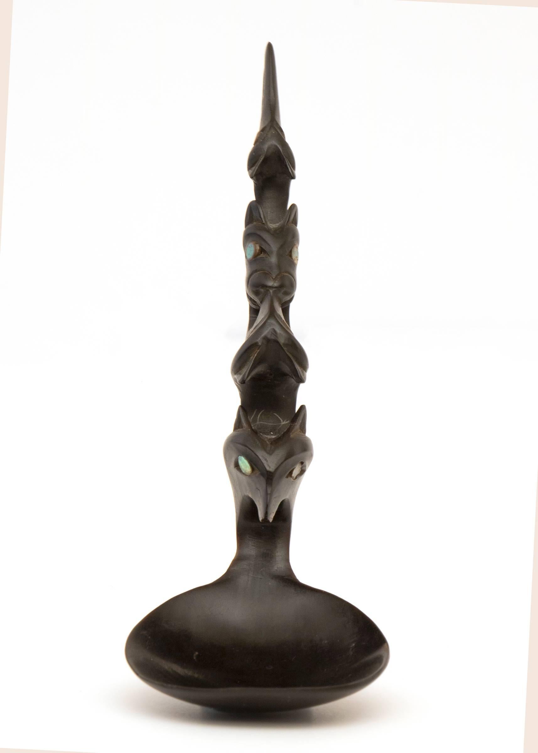 An American Indian/Northwest coast spoon or ladle exquisitely carved with animal effigies. Custom display stand is included. Overall dimensions with the stand are 8.5 x 3 x 3 inches; spoon measures 6 x 2 x 2 inches.

Carved horn spoons are
