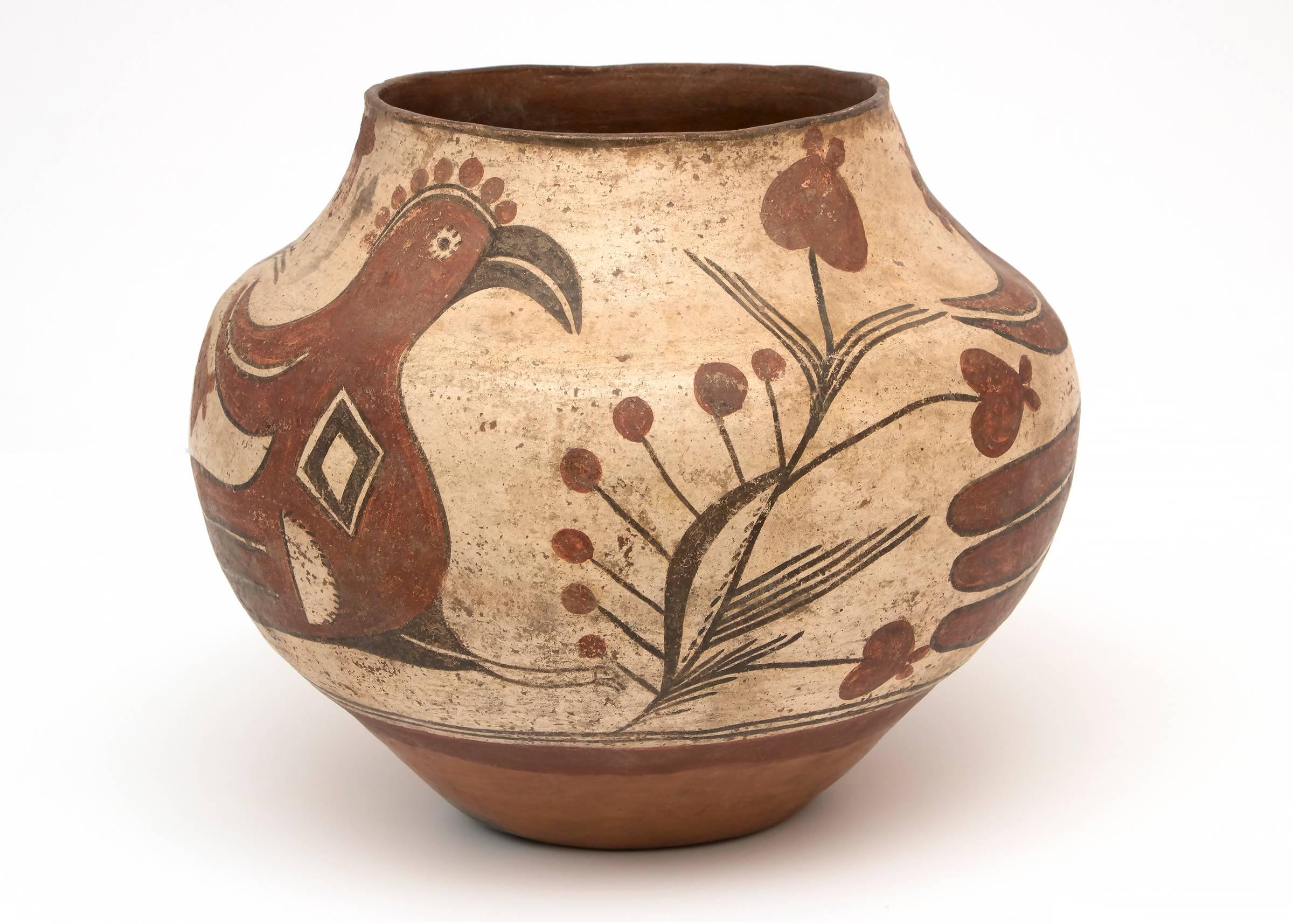 An early circa 1880 Southwestern Native American Pueblo Pottery jar.  The polychrome earthenware Zia bird olla was constructed by hand of native clay and meticulously painted in slip glazes by a Zia potter.  Zia Pueblo is located 18 miles northwest