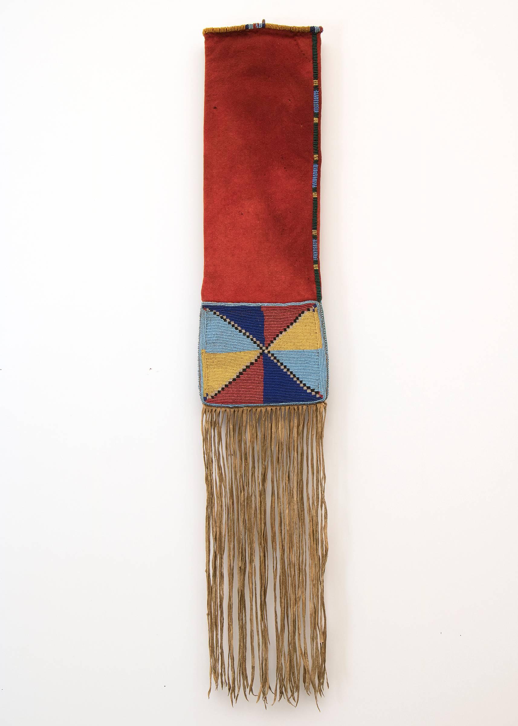 A unique 19th century American Indian pipe bag (tobacco bag). Constructed of red trade cloth with native tanned hide fringe. Intricately beaded different designs on either side.

The Plateau cultural area encompasses portions of what is now