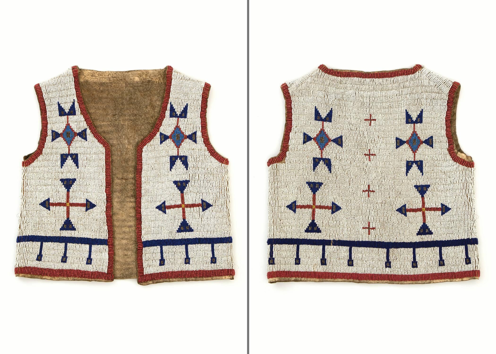 19th century antique Sioux (Native American/Plains Indian) child's beaded vest constructed of native tanned hide and beaded in blue, white-heart red, white and metallic trade beads. Pictorial design elements include cross or cruciform motifs and